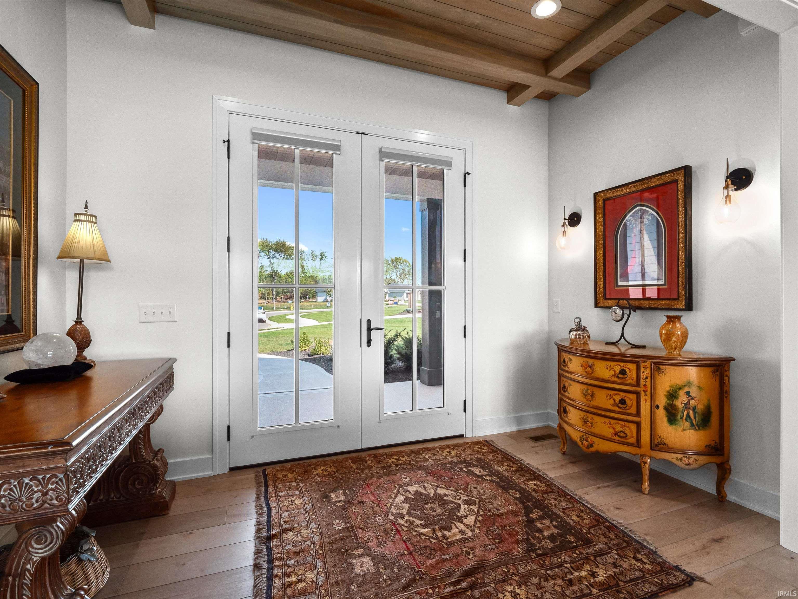 Doorway to outside with french doors, hardwood / wood-style floors, and a wooden ceiling with exposed beams