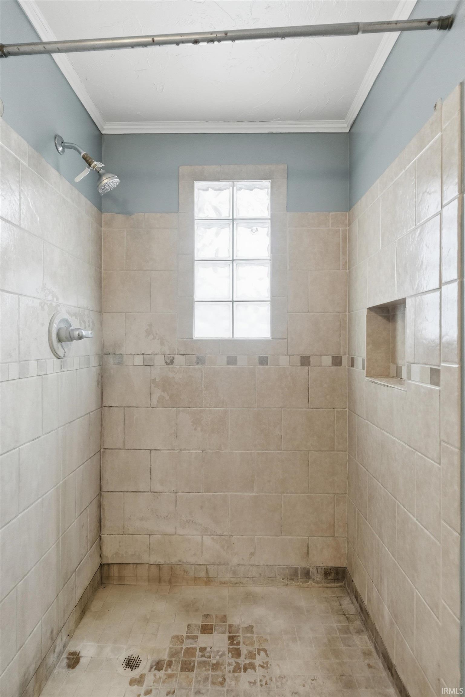 Full bath with a tile shower
