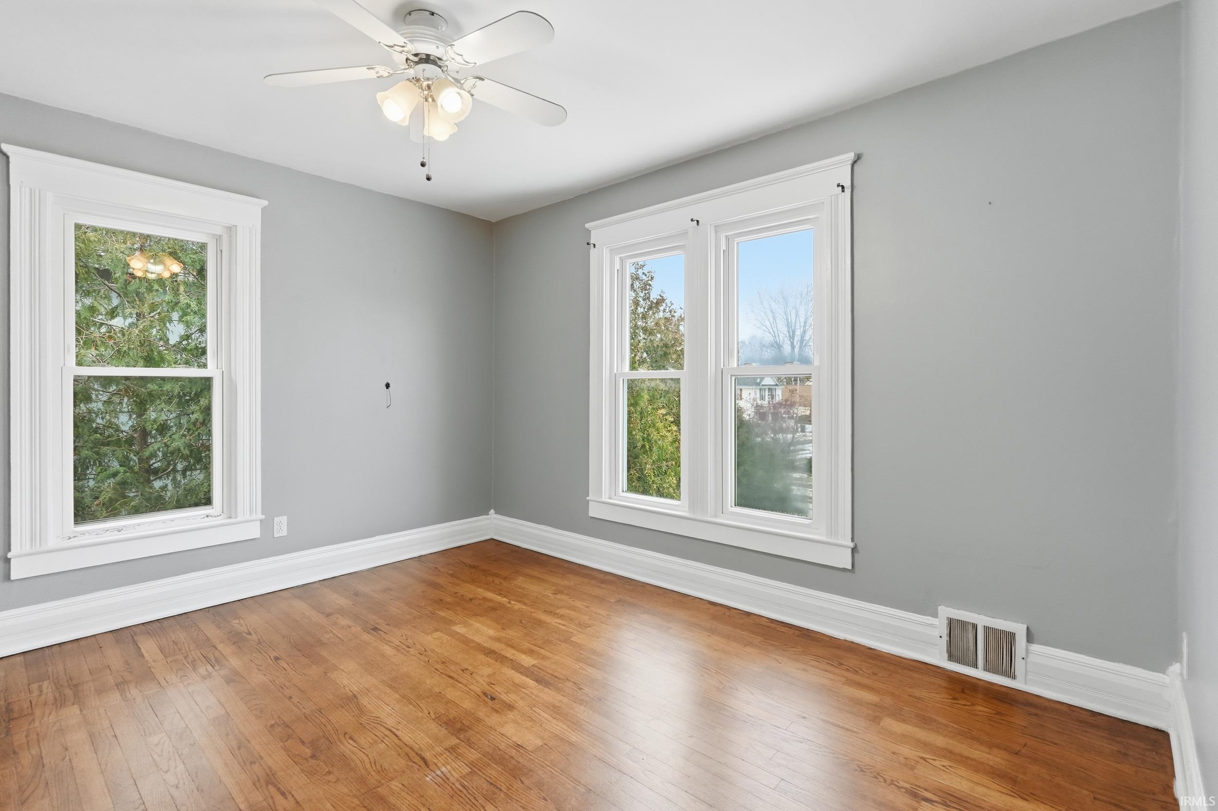 Unfurnished room featuring light wood-style floors and ceiling fan
