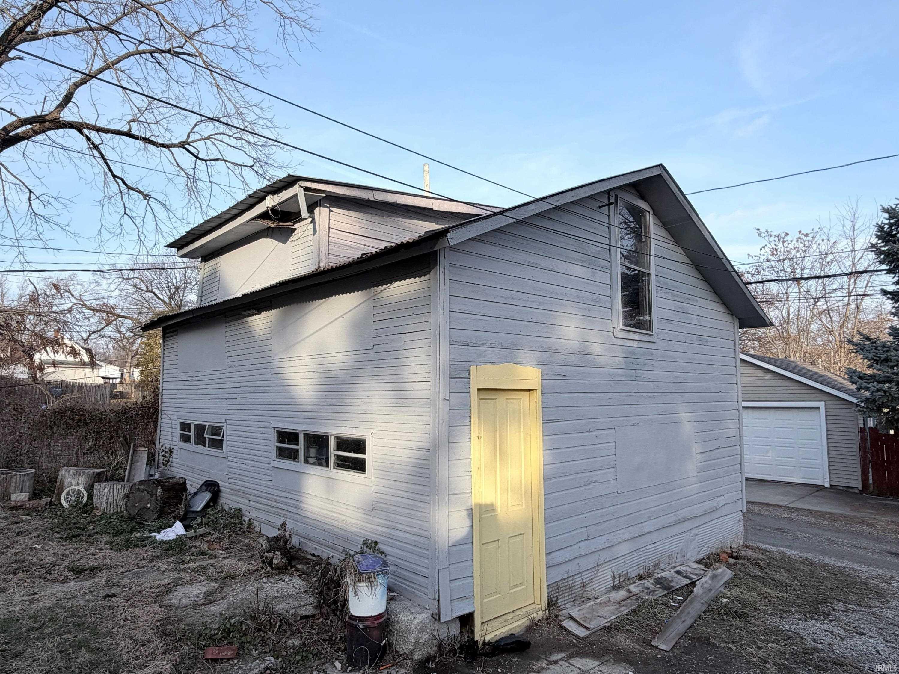 View of home's exterior featuring a garage and an outdoor structure