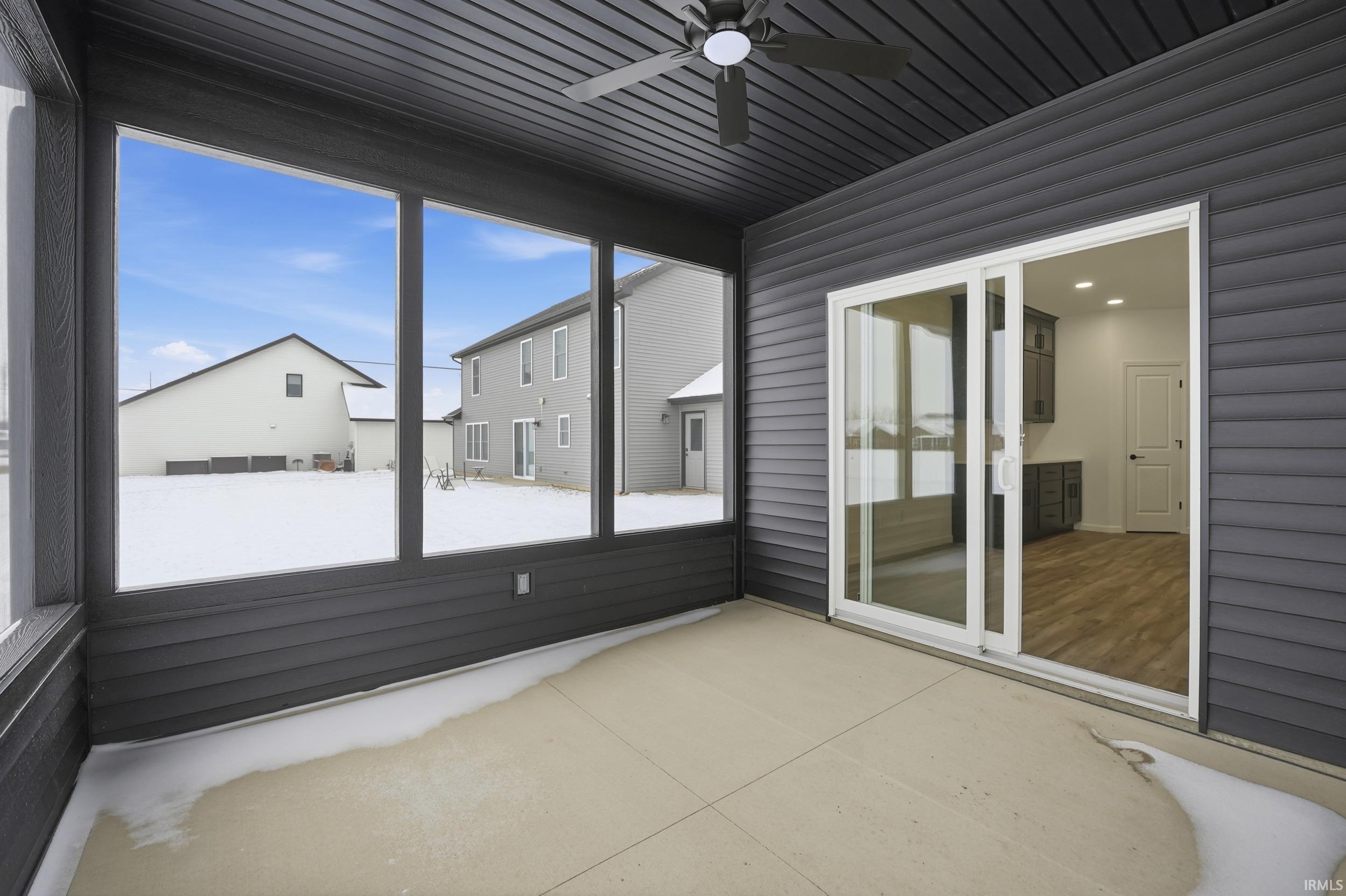 Unfurnished sunroom featuring ceiling fan