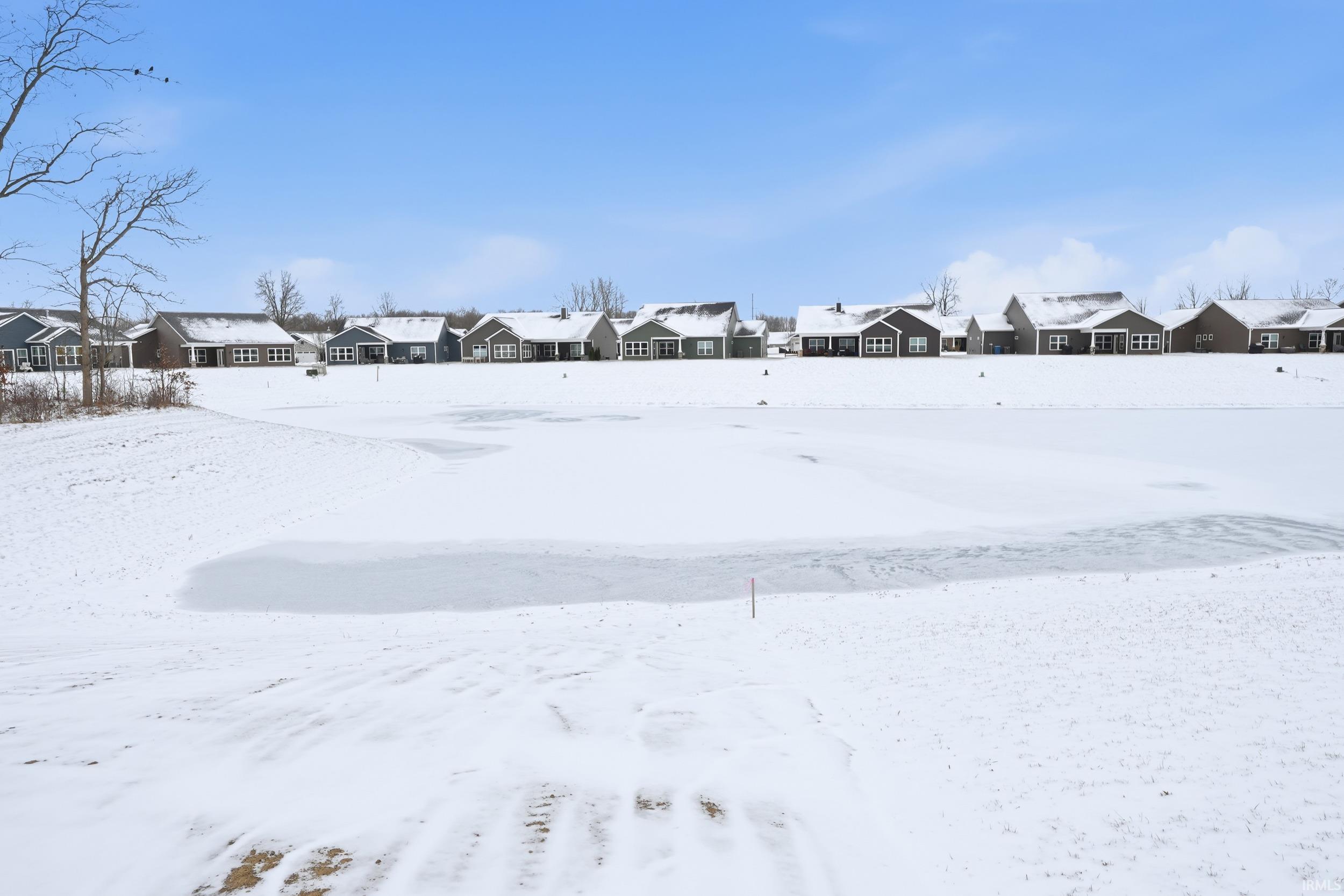 Yard covered in snow featuring a residential view