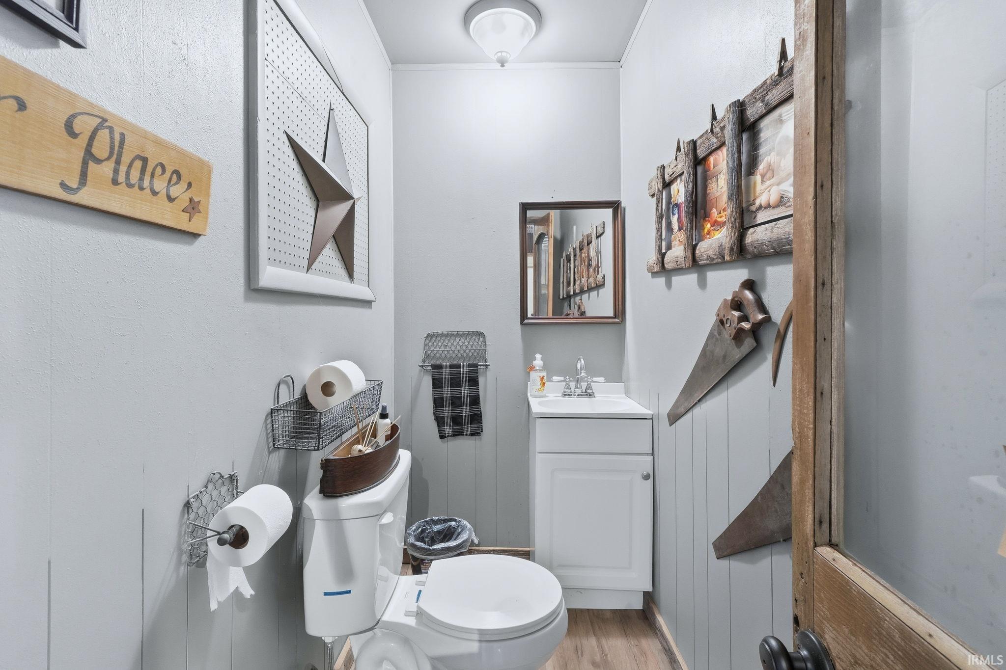 Half bathroom featuring vanity and light wood-type flooring