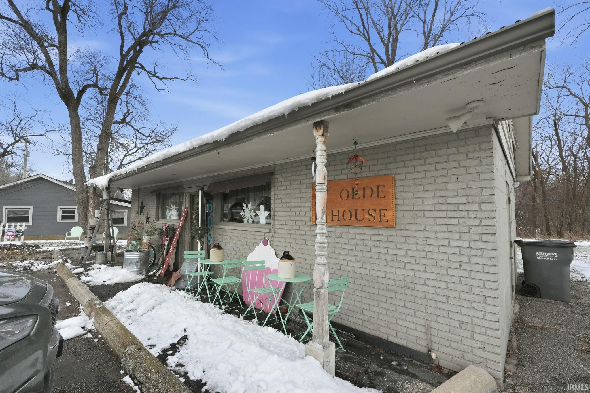 View of snowy exterior with brick siding