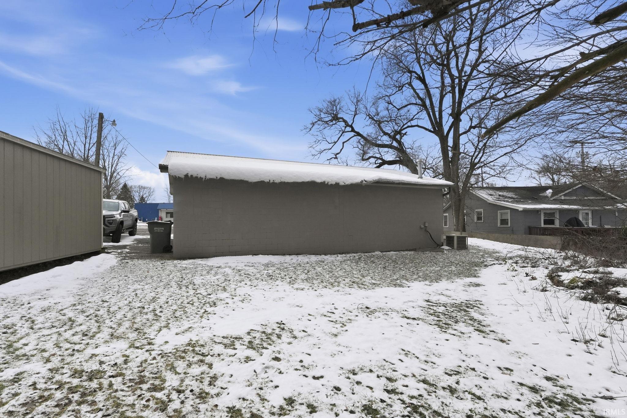 View of snow covered back of property