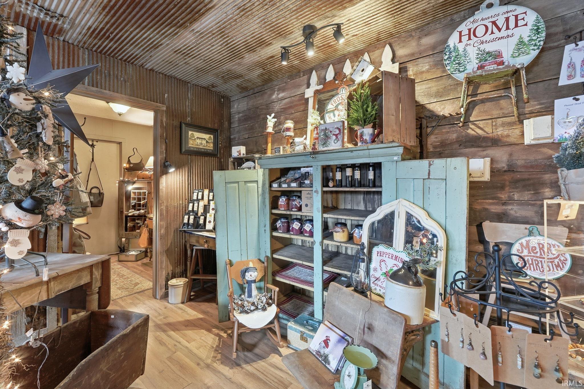 Miscellaneous room with wood walls and hardwood / wood-style flooring