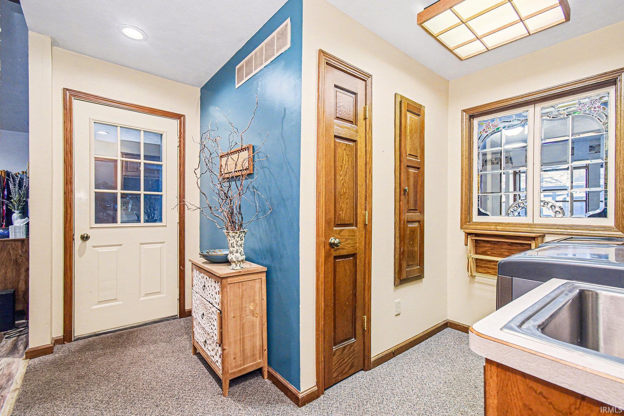 Hall featuring light carpet and recessed lighting