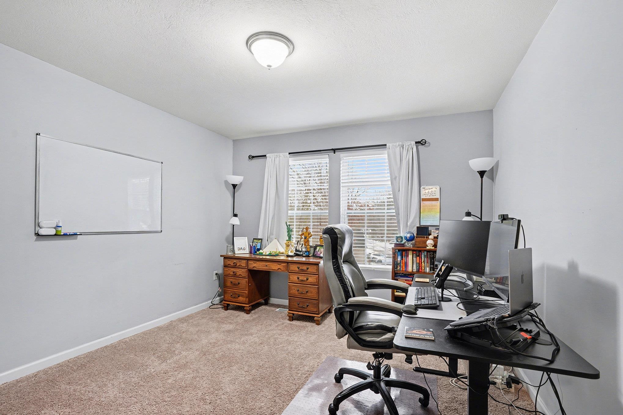 Bedroom used as a Home office with carpet floors