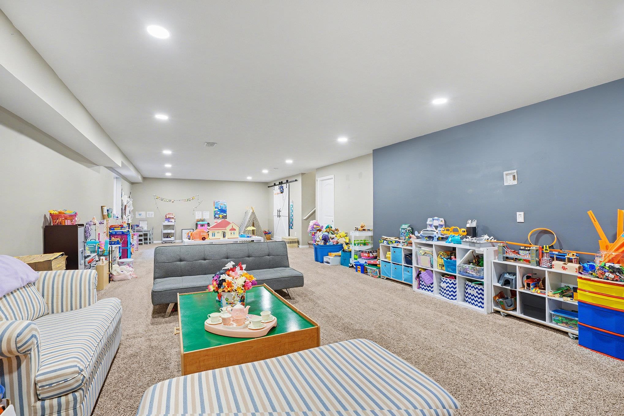Game room with carpet floors and recessed lighting
