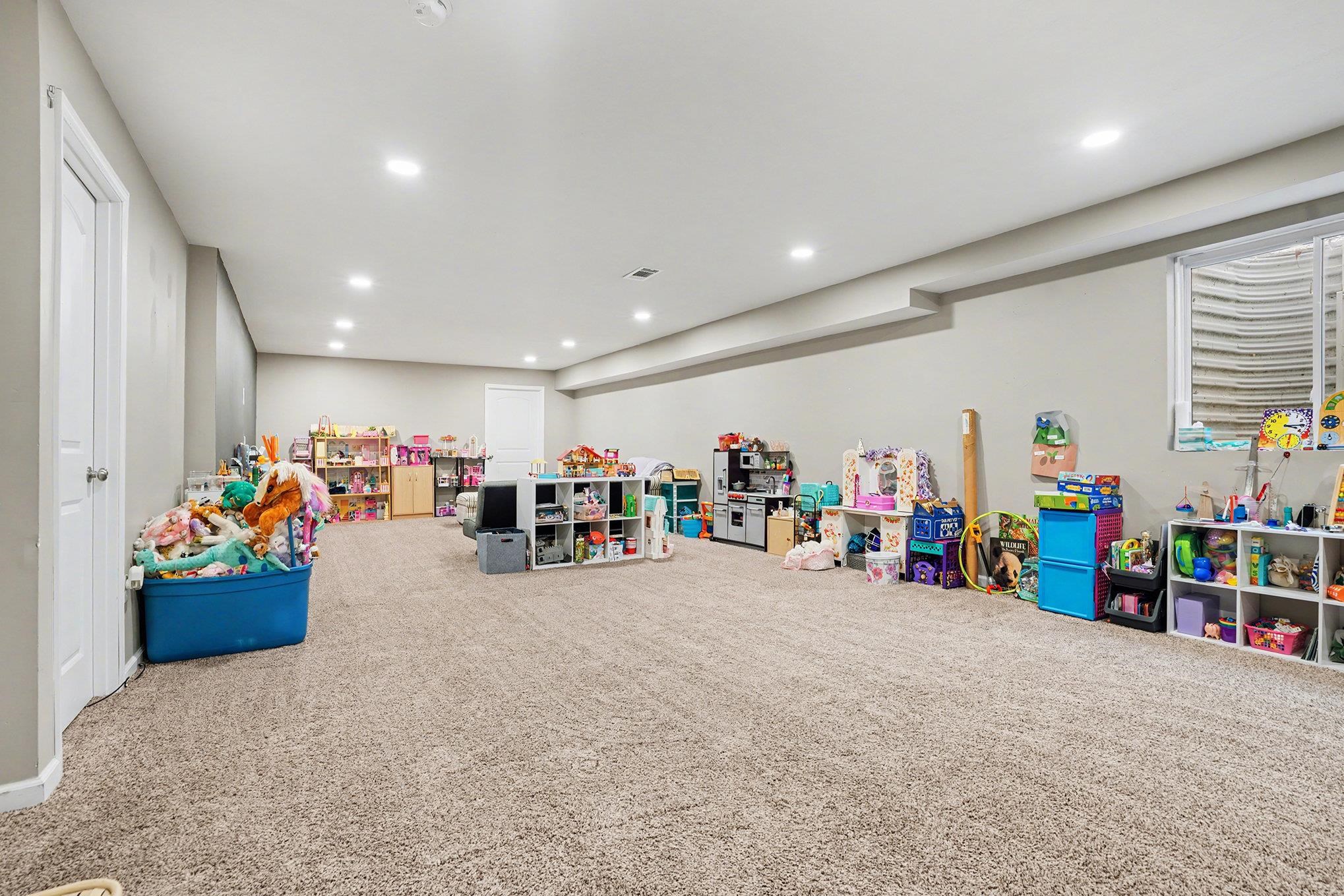 Recreation room with carpet flooring and recessed lighting