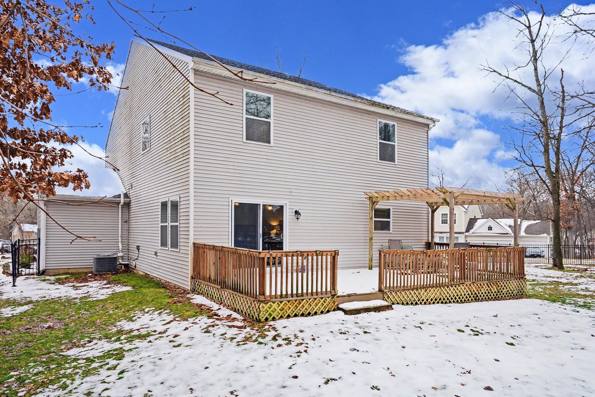 Snow covered property with a wooden deck