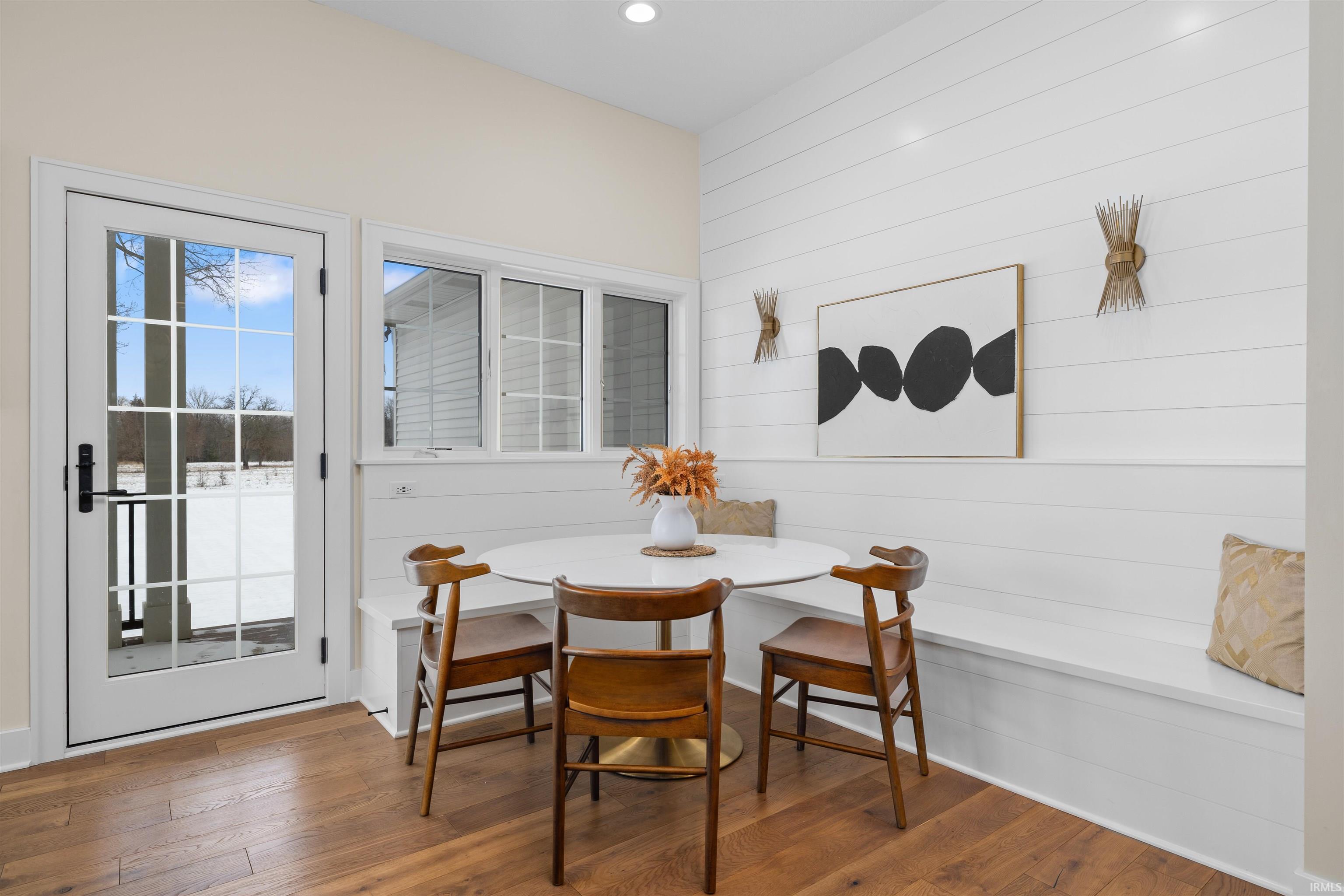 Dining room with breakfast area, hardwood / wood-style flooring, and wooden walls