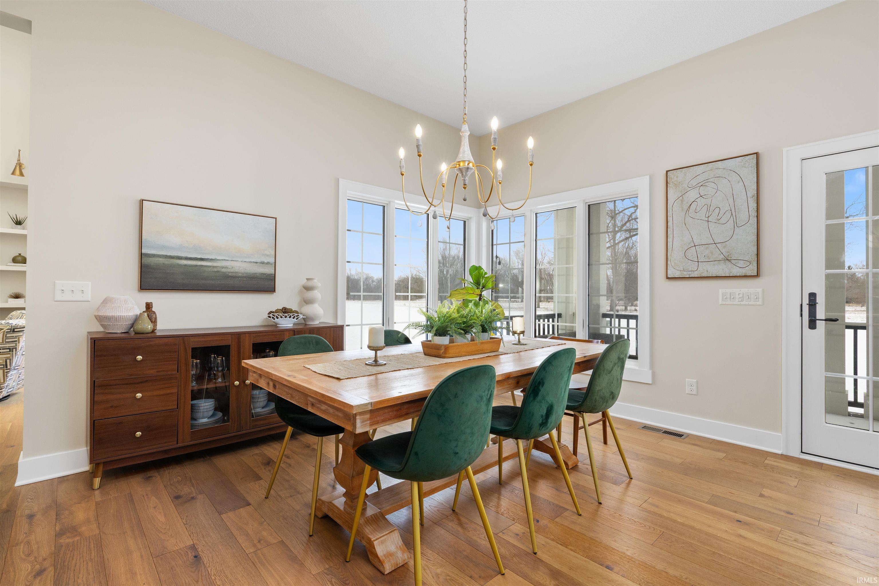 Dining area featuring light wood-style floors and a chandelier
