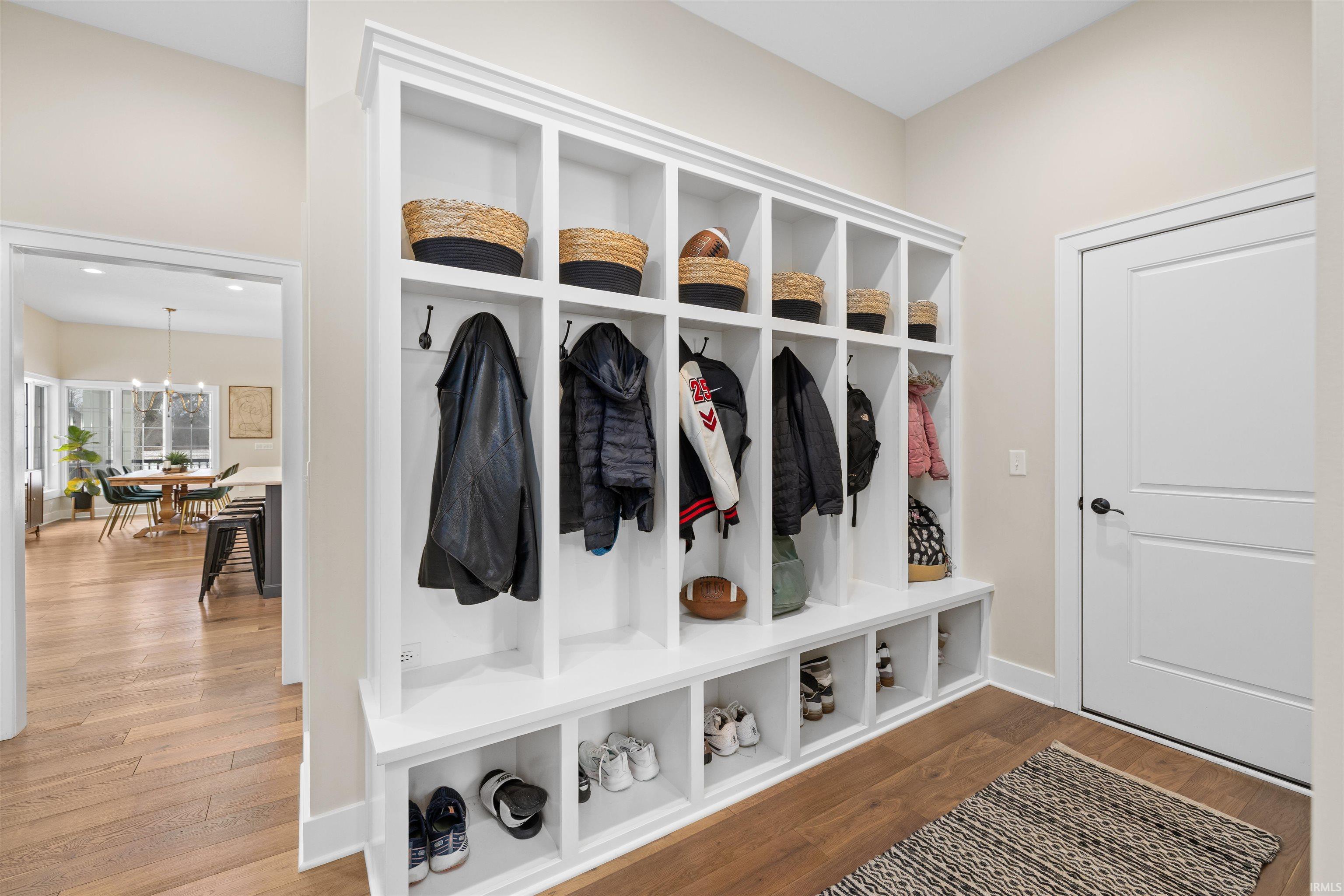 Mudroom with wood finished floors and baseboards