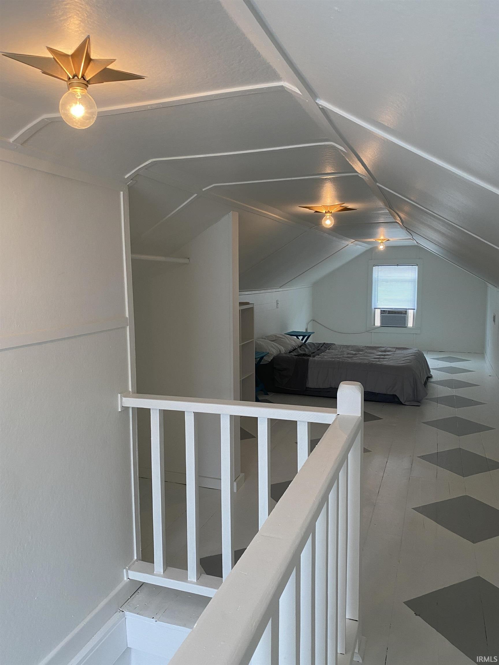 Corridor featuring vaulted ceiling