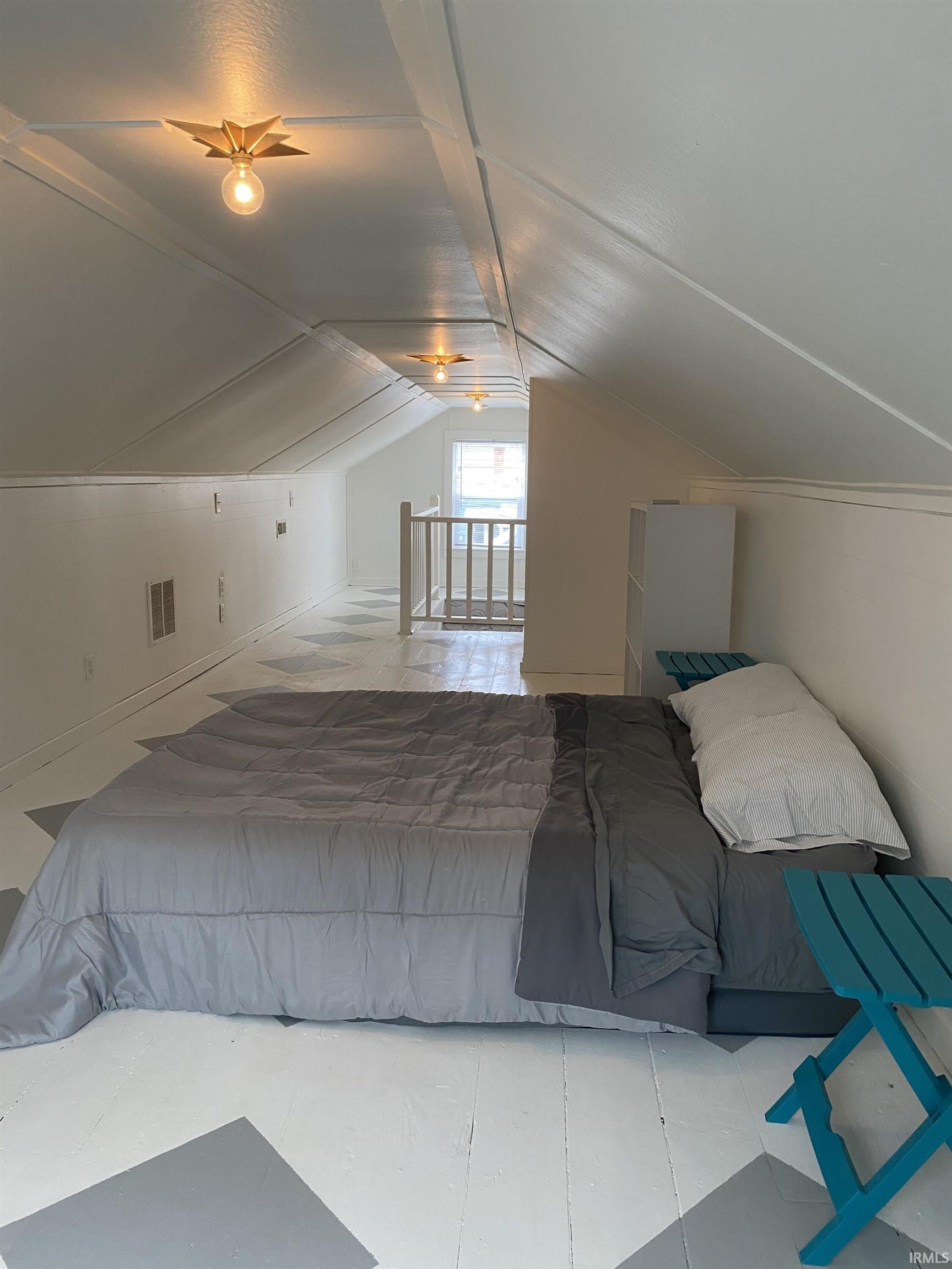 Bedroom with lofted ceiling