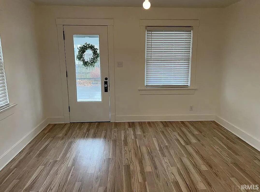 Foyer entrance featuring light wood-type flooring and baseboards