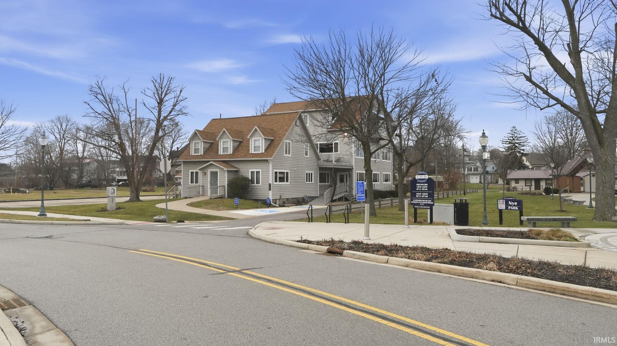 View of asphalt road with sidewalks, curbs, and a residential view