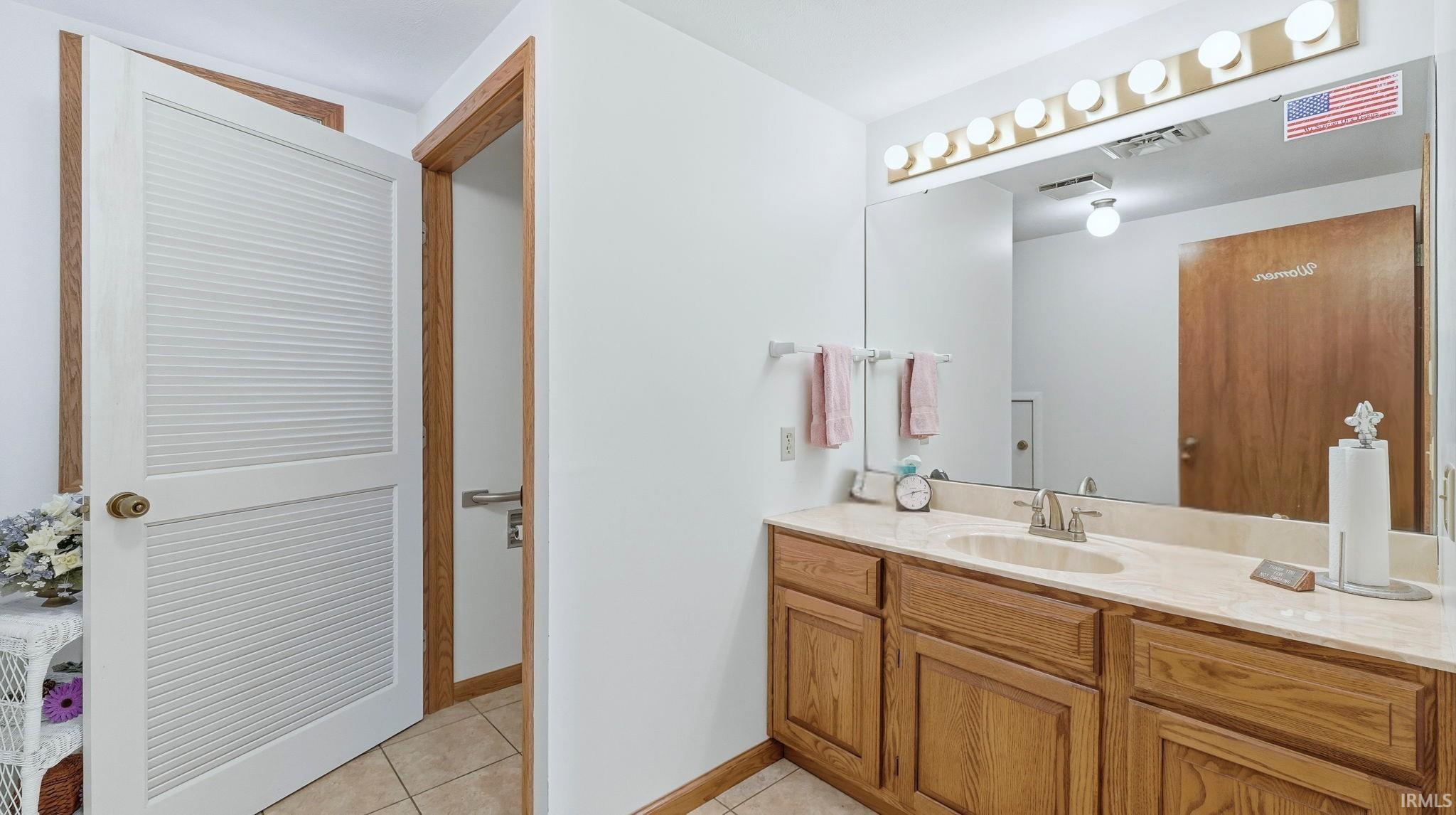 Bathroom featuring vanity and light tile patterned floors