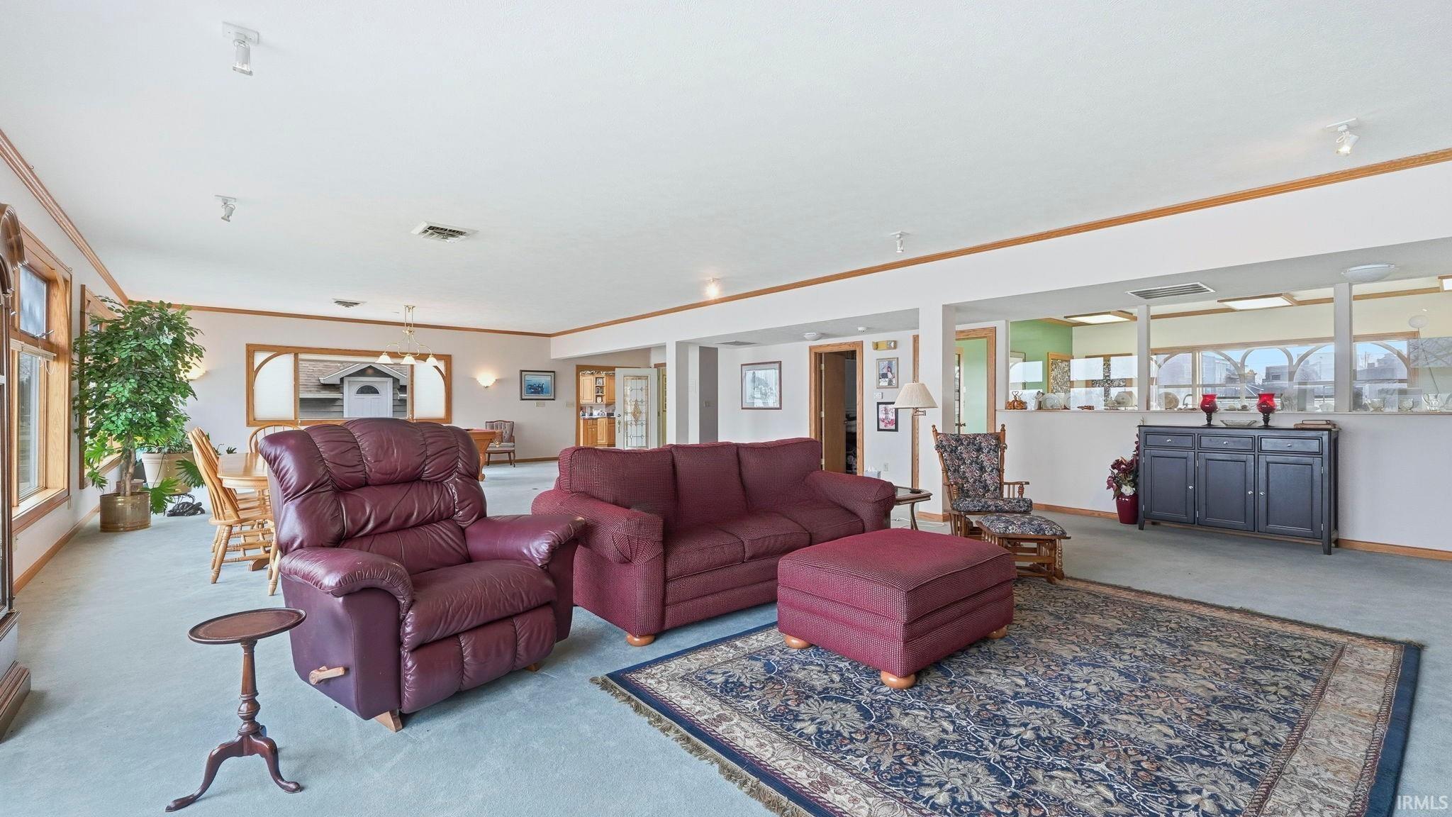 Living area with carpet and ornamental molding