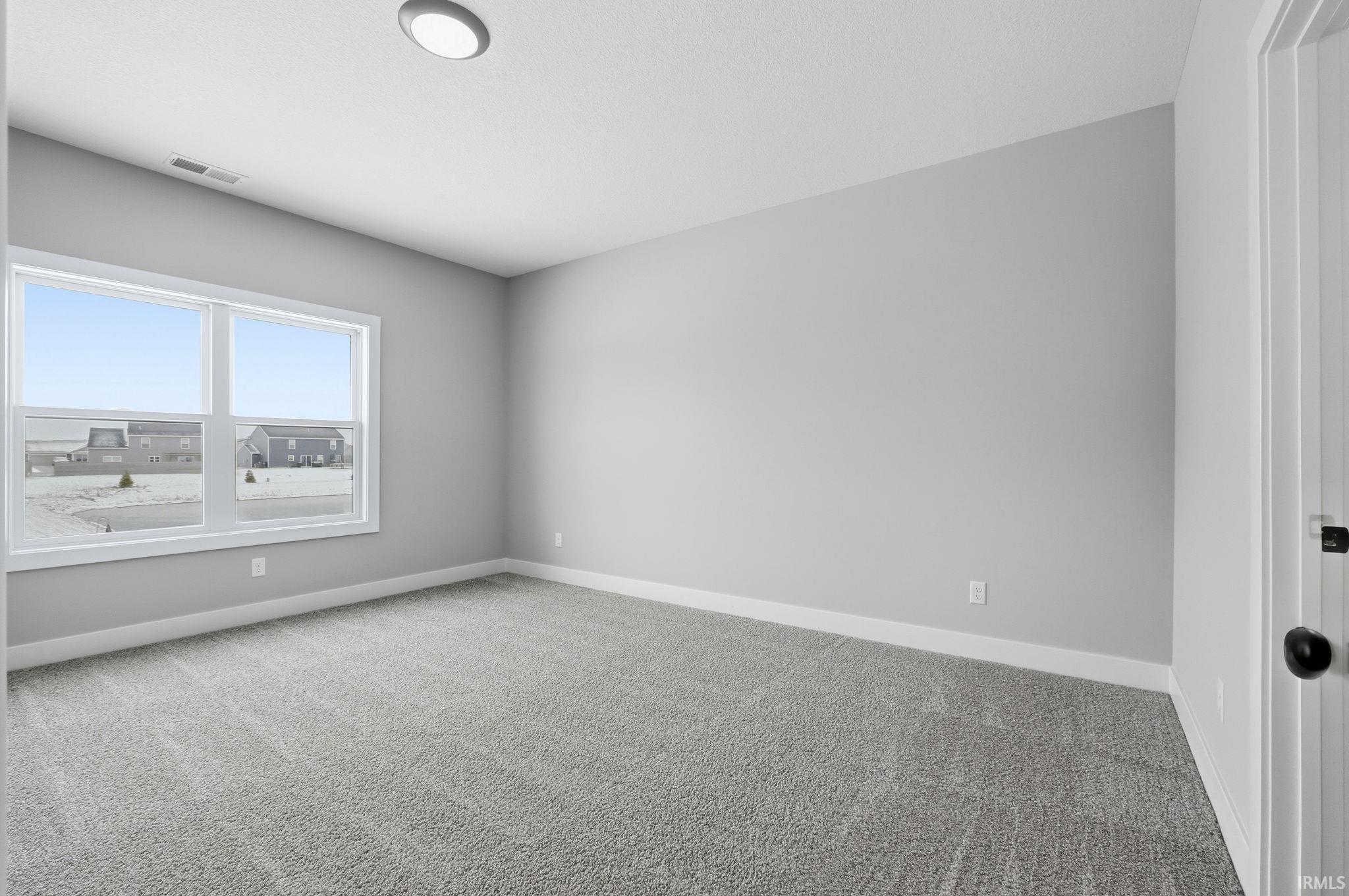 Unfurnished room featuring carpet floors and baseboards