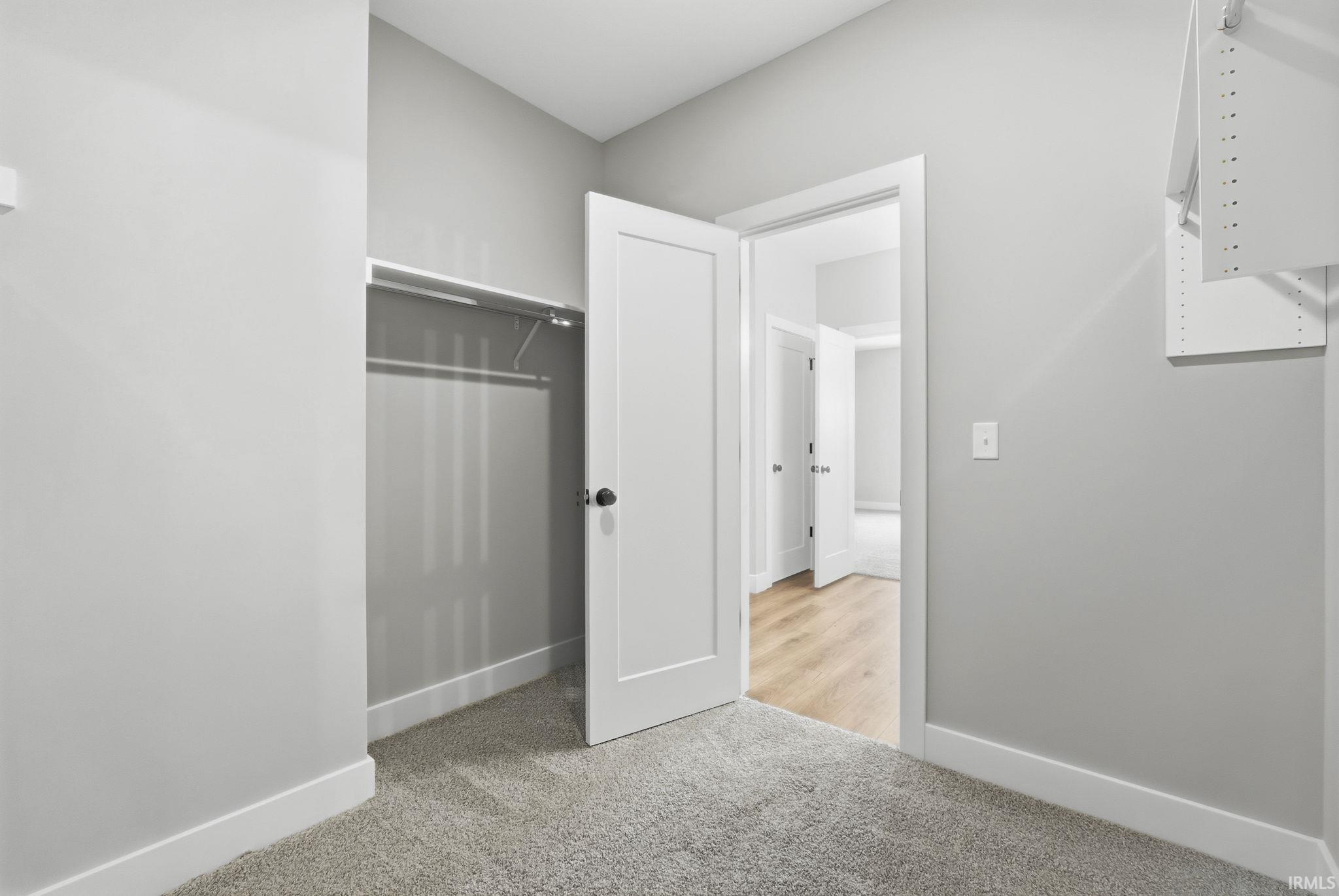 Unfurnished bedroom featuring light colored carpet and a closet