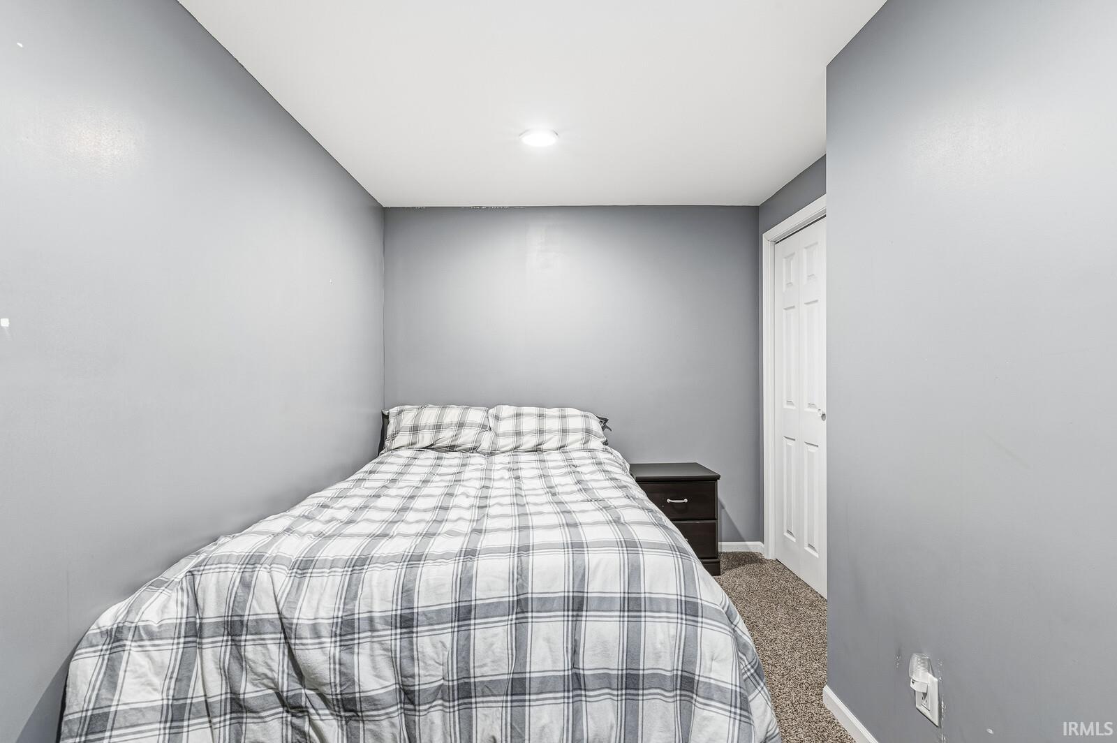Carpeted bedroom with baseboards