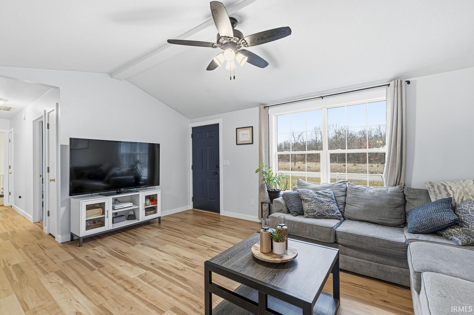 Living area with ceiling fan and light wood-type flooring