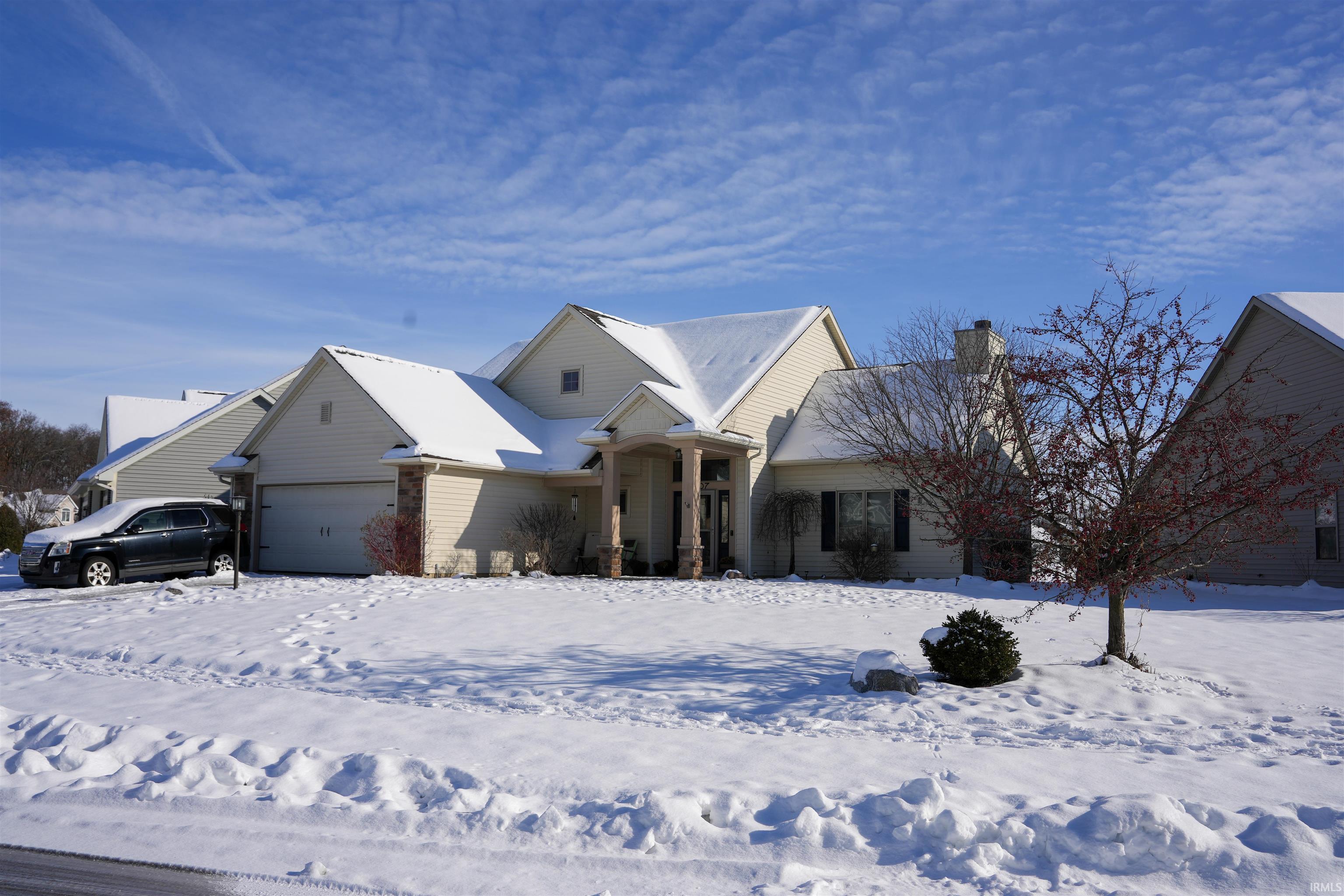 View of front of property with a garage and a chimney