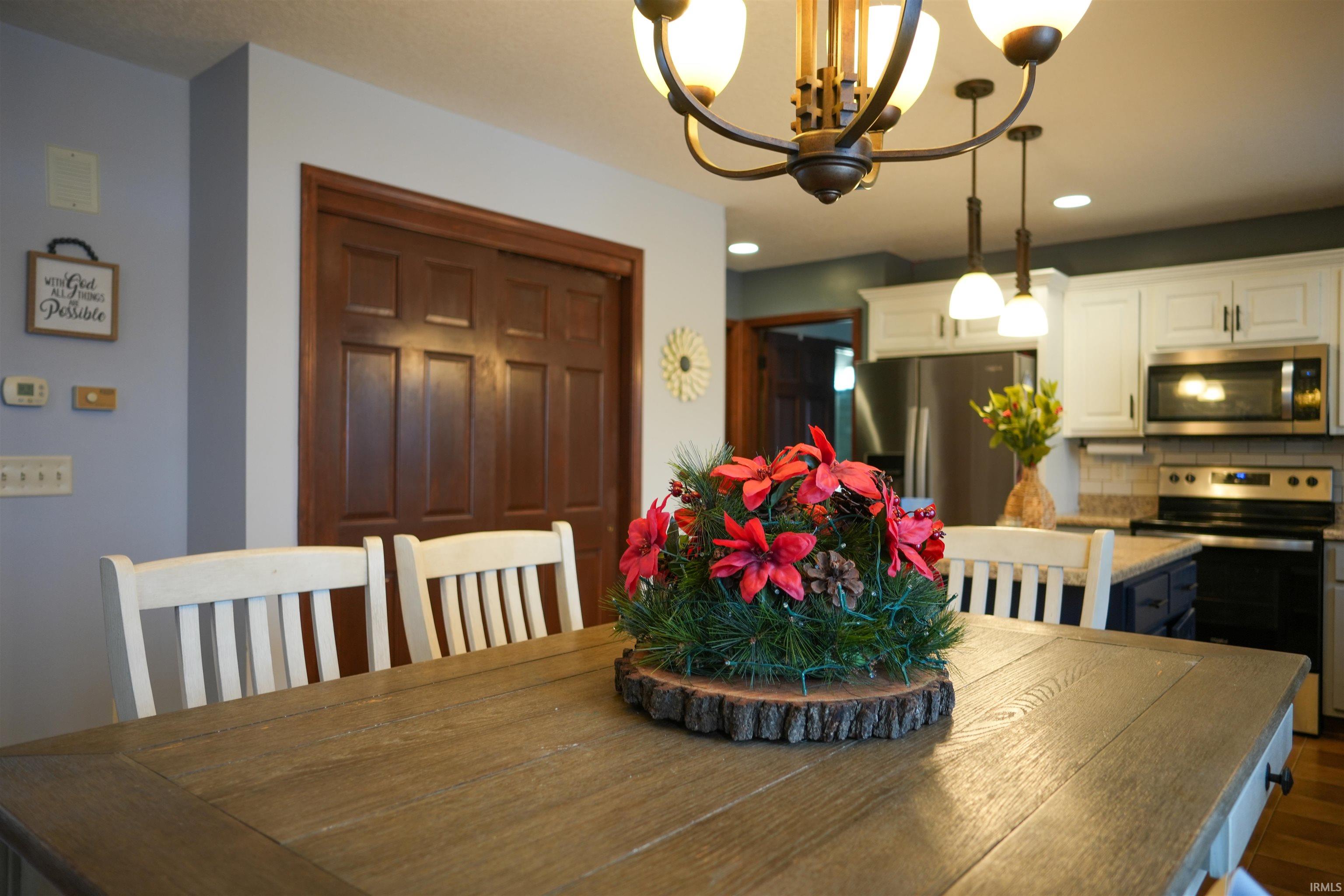 Dining area with a chandelier and recessed lighting