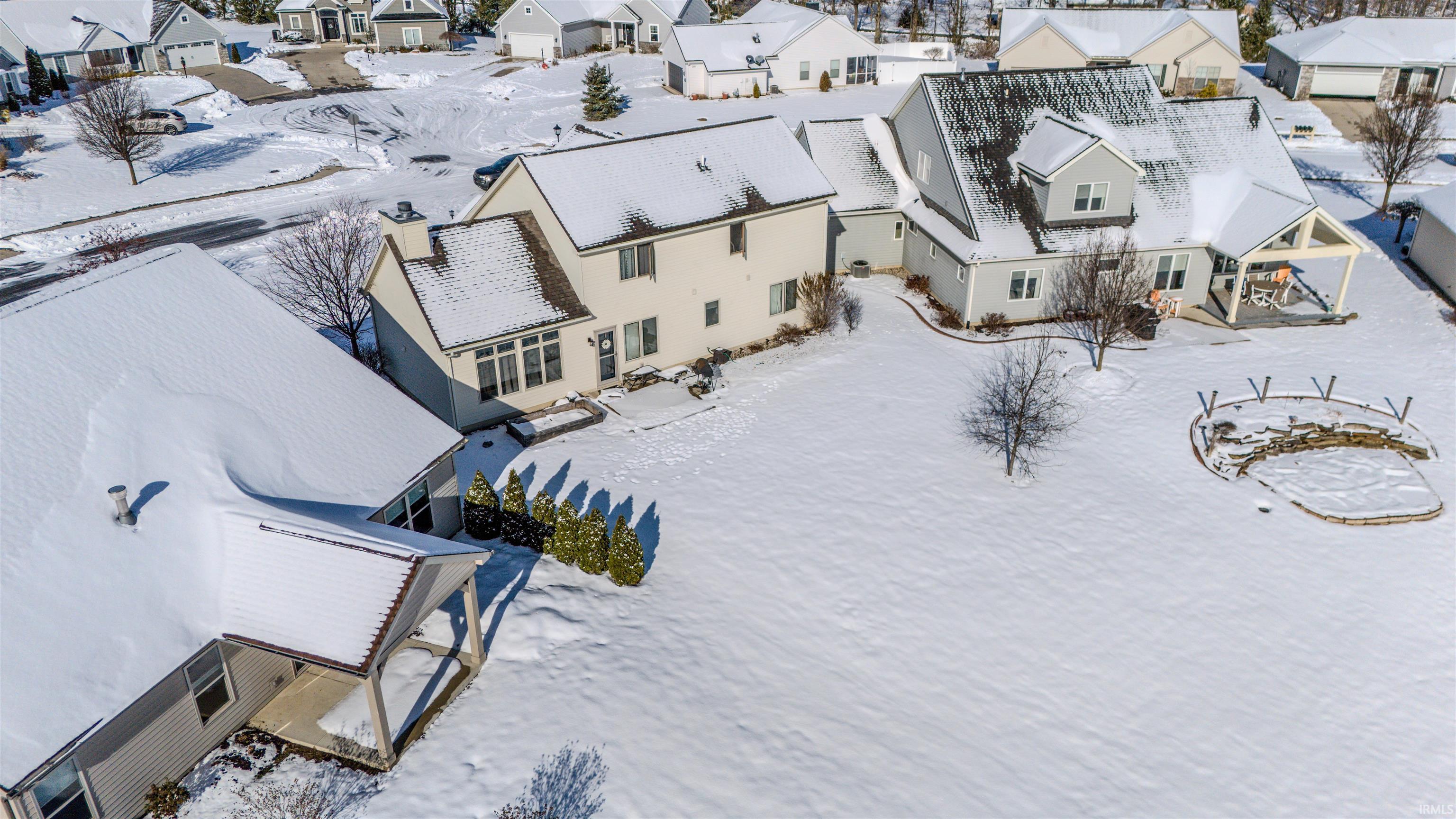 Snowy aerial view with a residential view