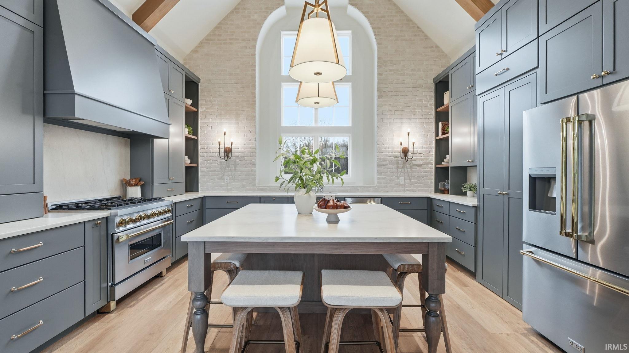Kitchen with open shelves, premium appliances, vaulted ceiling, a kitchen island, and gray cabinetry