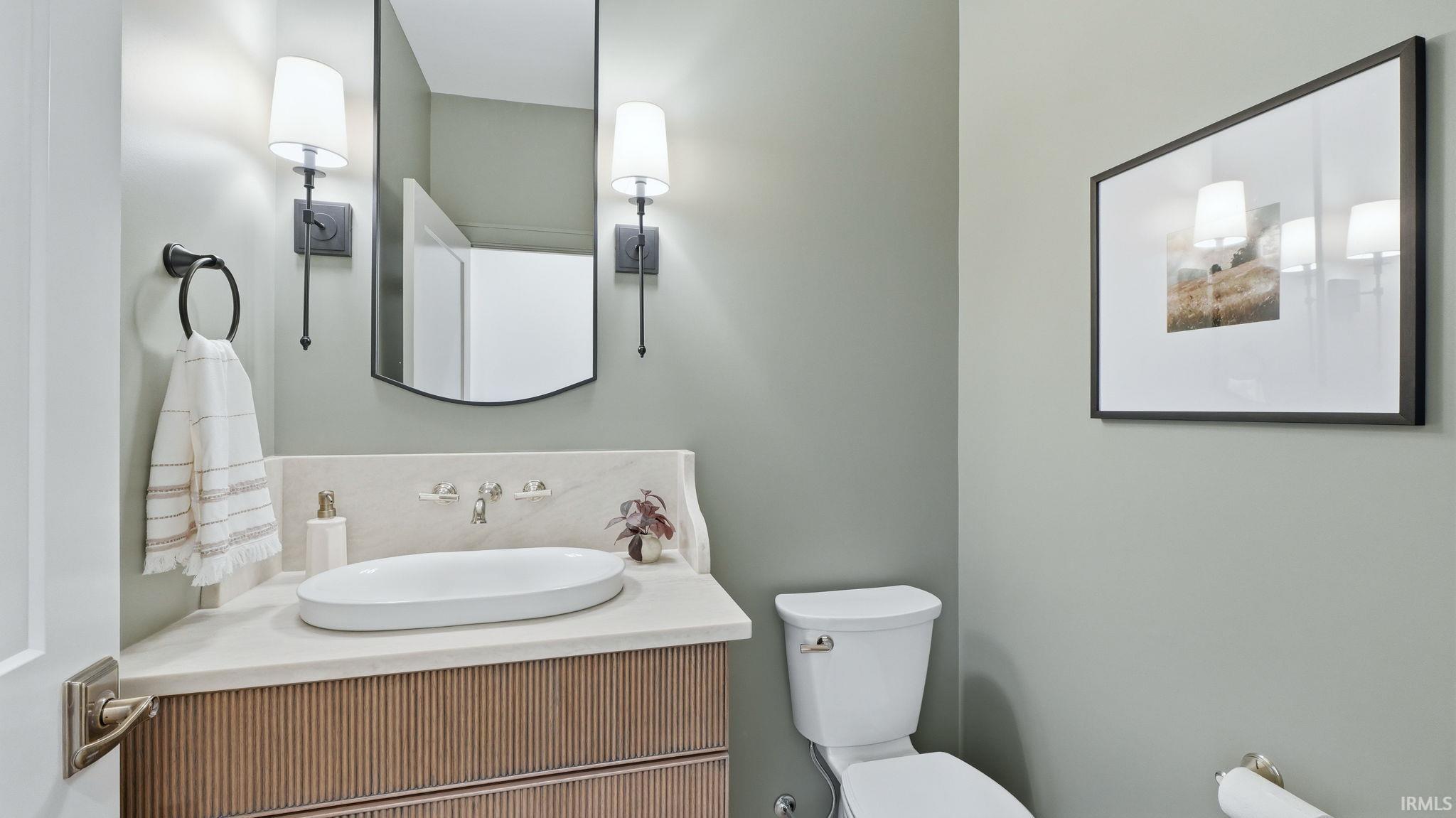 Half bathroom with toilet and vanity