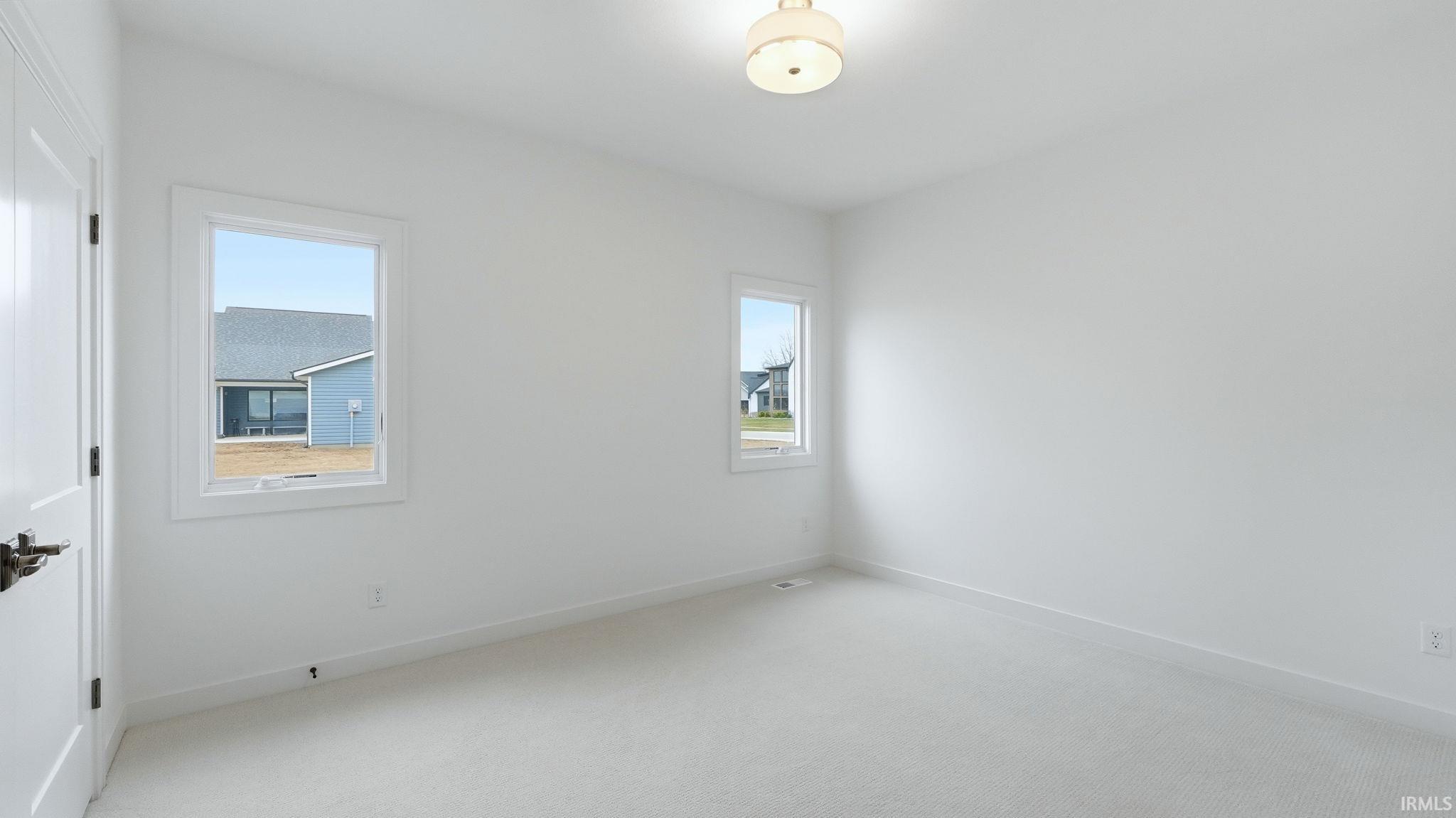 Spare room with light carpet and plenty of natural light