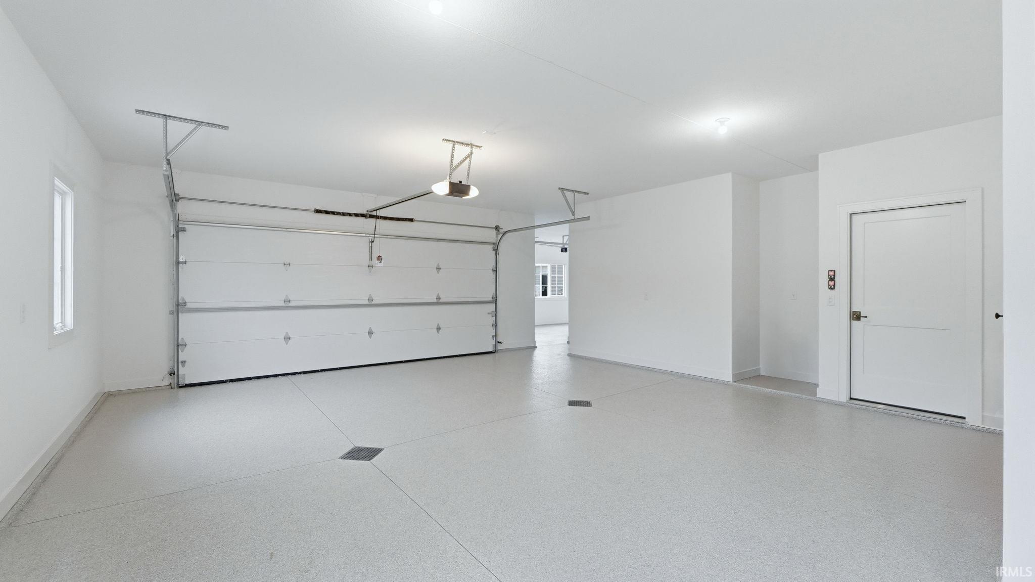 Garage featuring baseboards