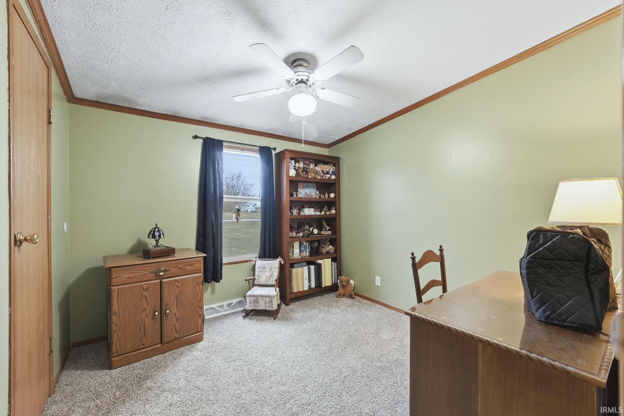Office featuring crown molding, light colored carpet, ceiling fan, and a textured ceiling