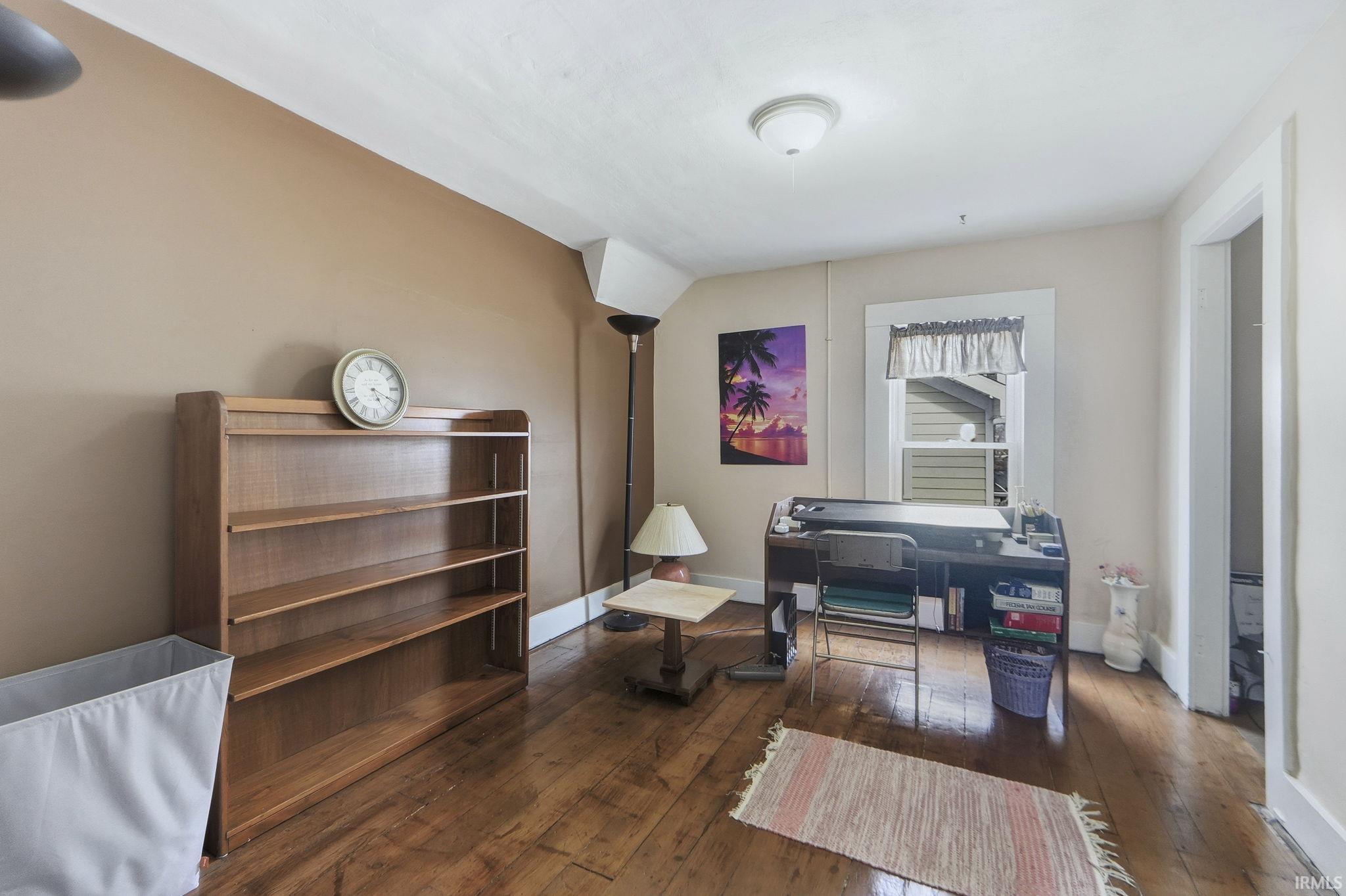 Living area with hardwood / wood-style flooring and baseboards