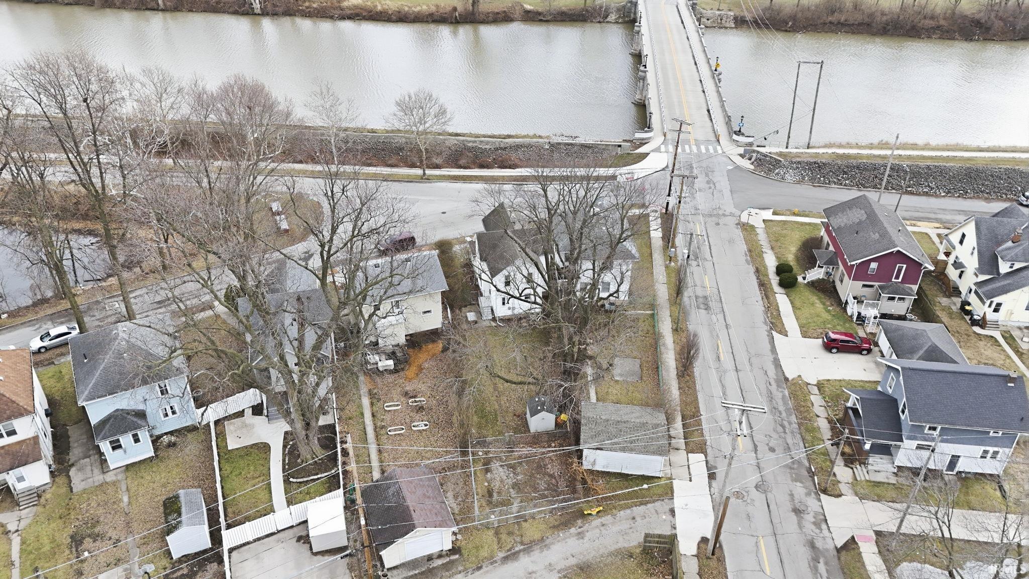 Aerial perspective of suburban area featuring a notable bridge and a nearby body of water