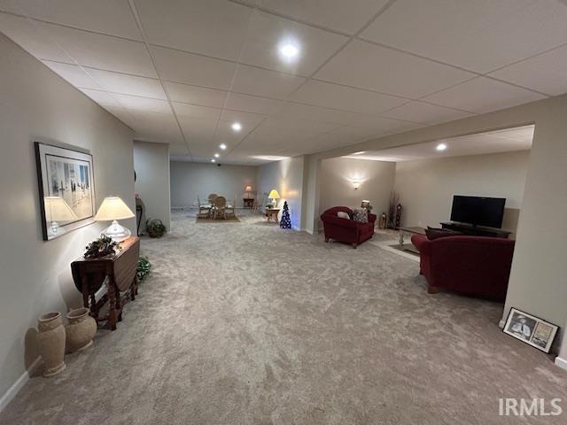 Living area featuring carpet, recessed lighting, and a paneled ceiling