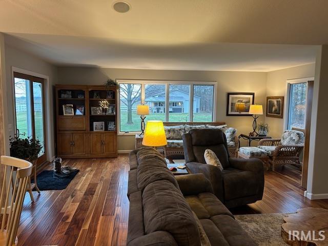 Living area with hardwood / wood-style floors and healthy amount of natural light