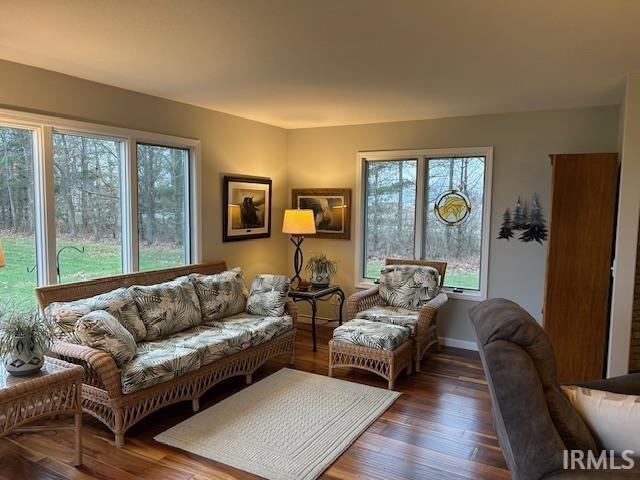 Living area featuring wood-type flooring and baseboards