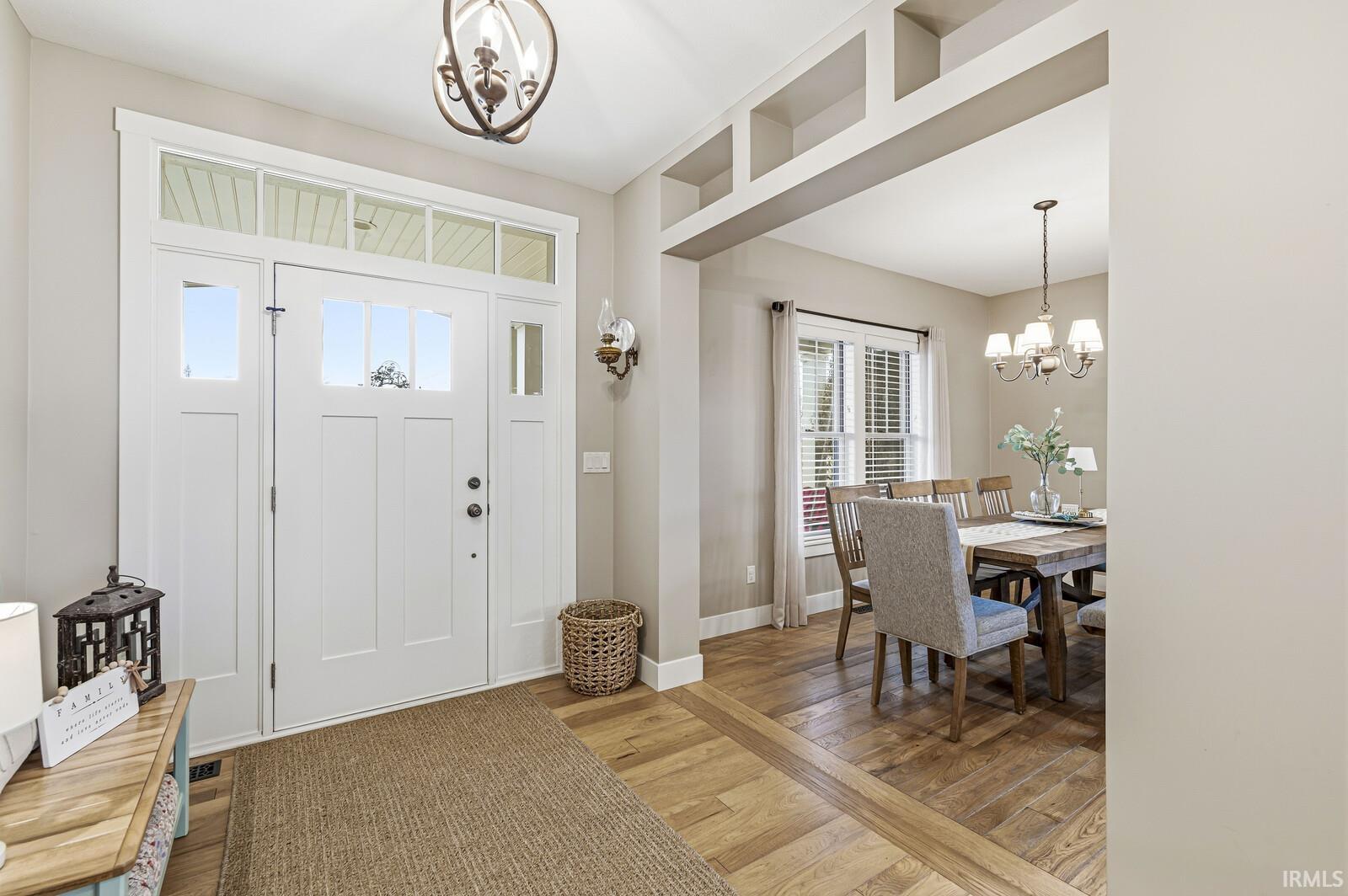 Foyer entrance featuring a chandelier and light wood finished floors