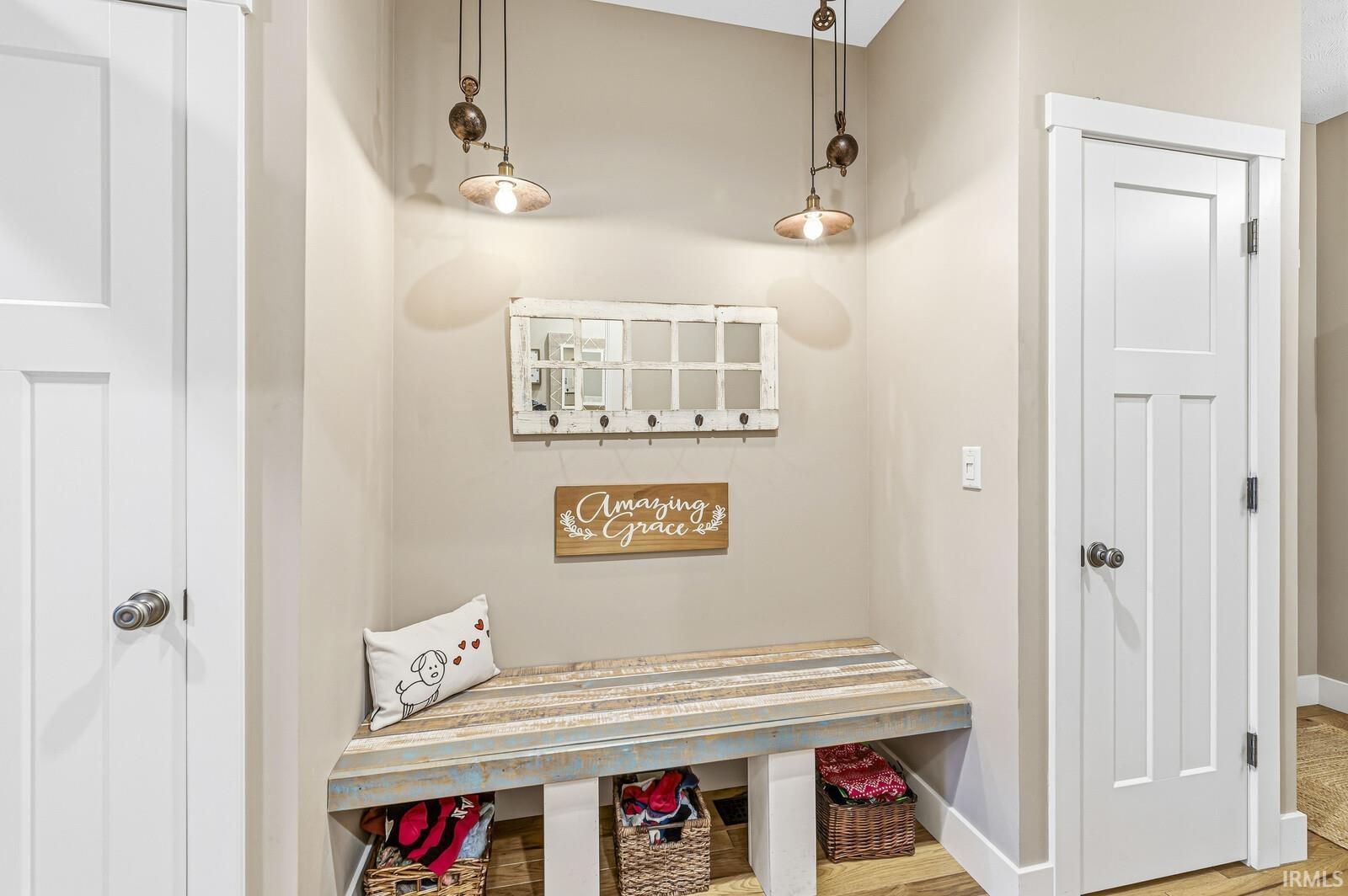 Mudroom featuring baseboards and wood finished floors