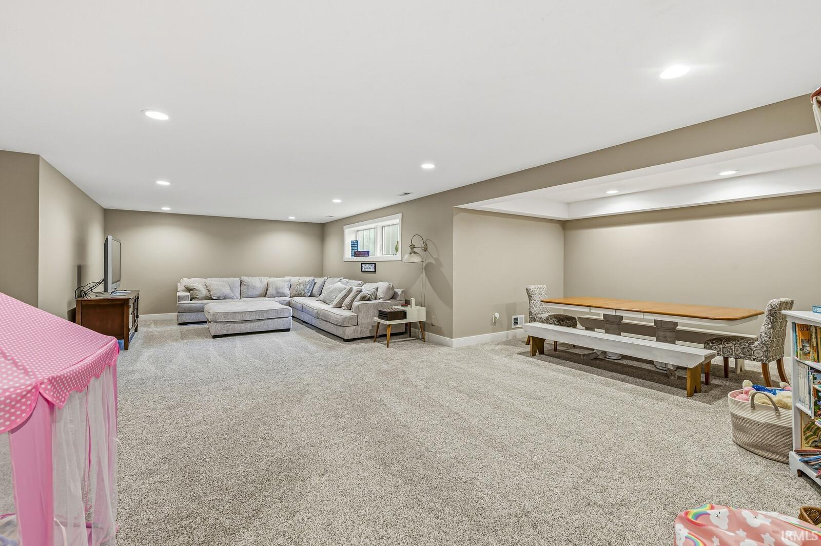 Living area featuring carpet and recessed lighting