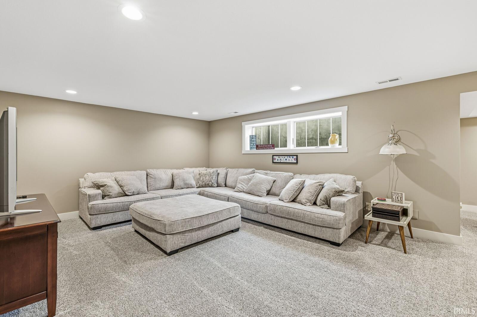 Living room with carpet floors and recessed lighting