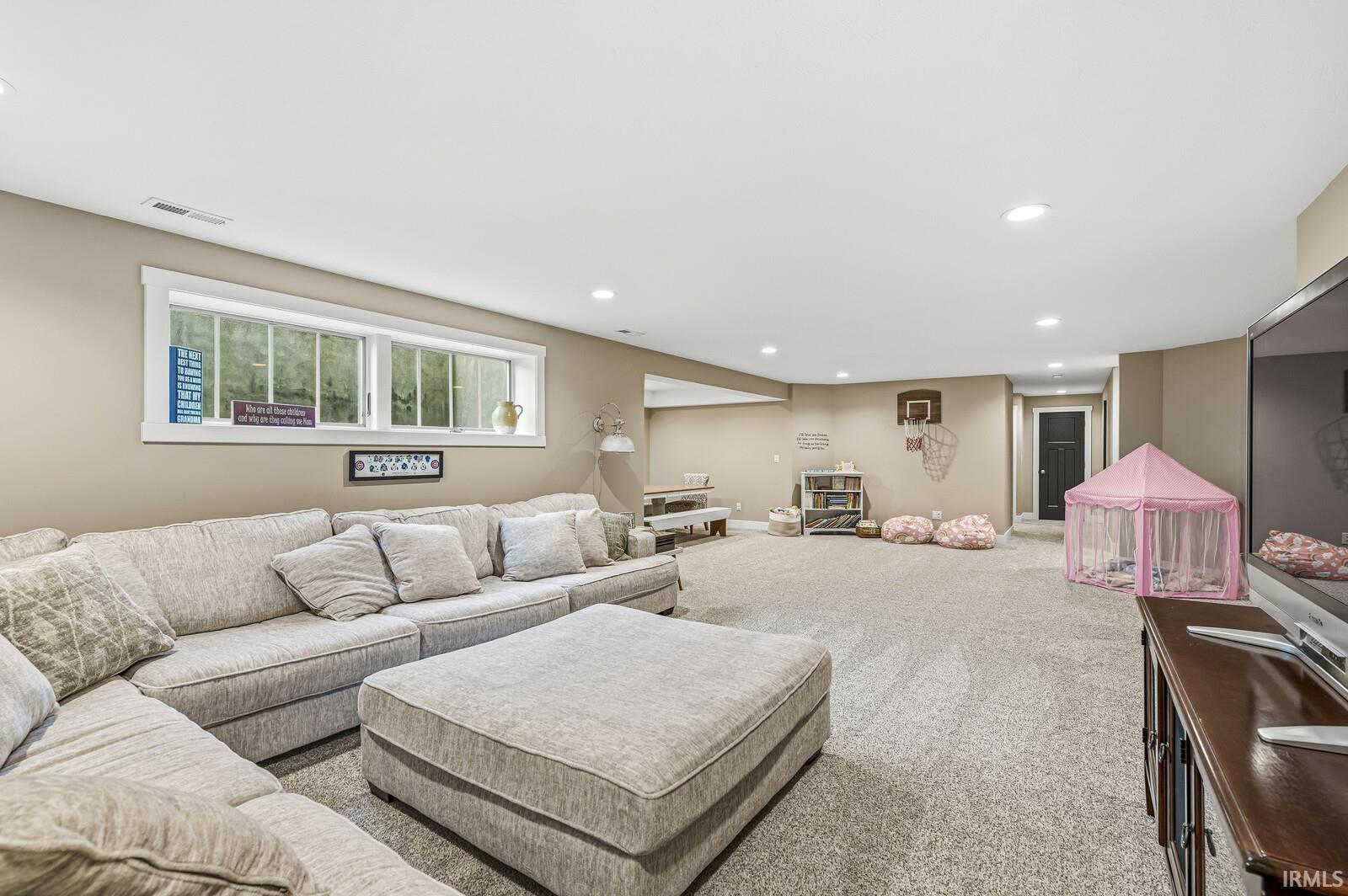 Living room with carpet flooring and recessed lighting