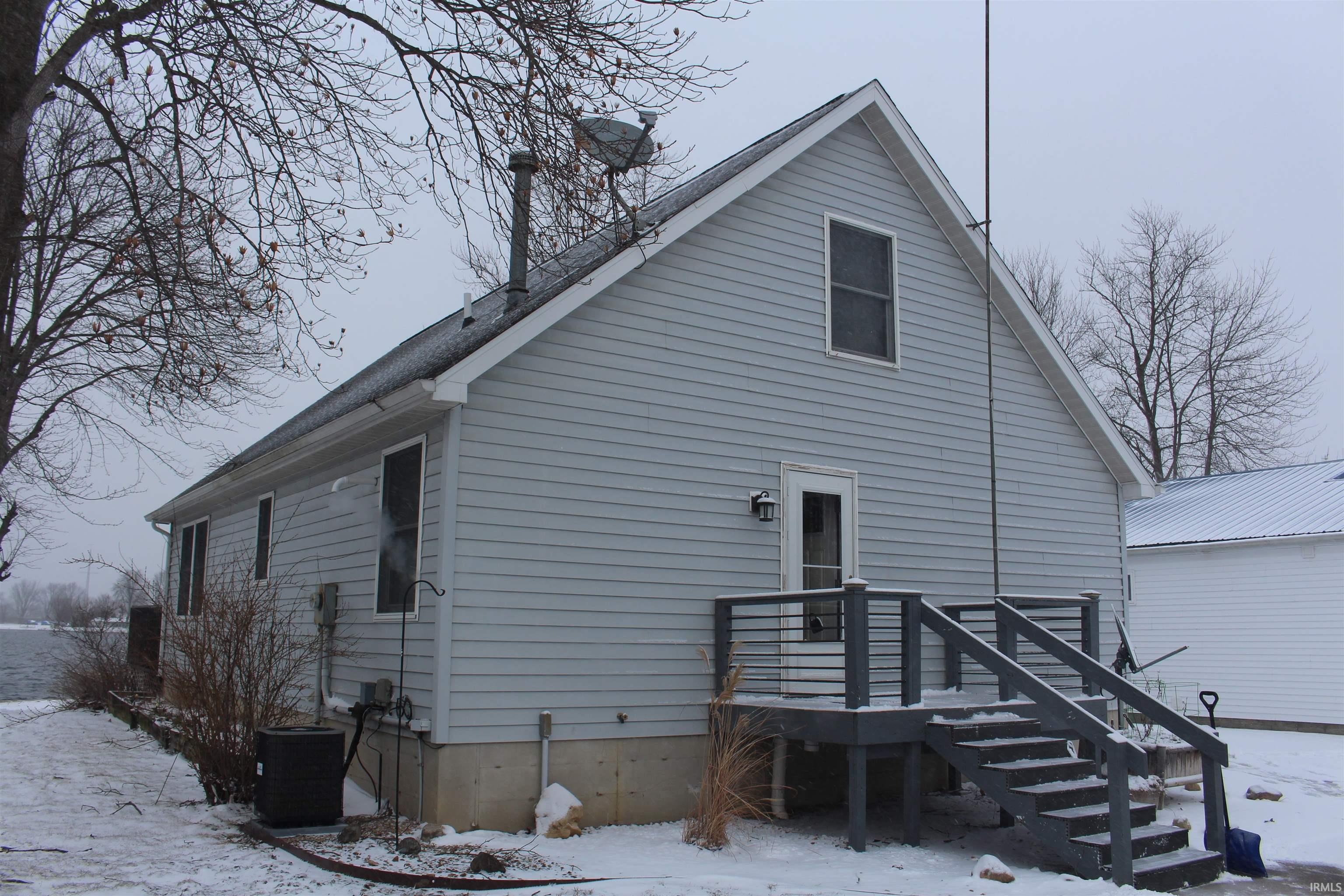 Snow covered property featuring a chimney