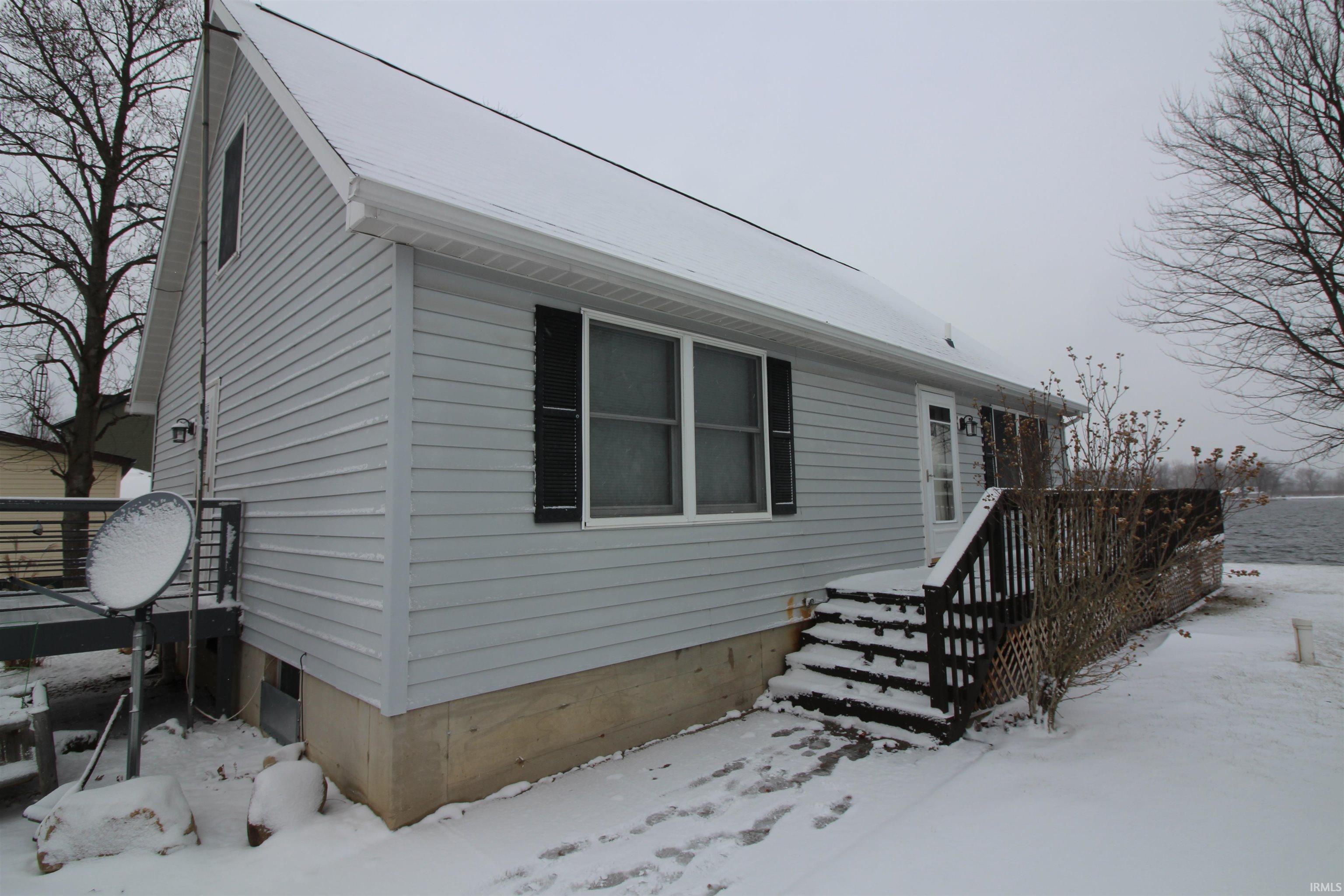 View of snow covered exterior with a deck