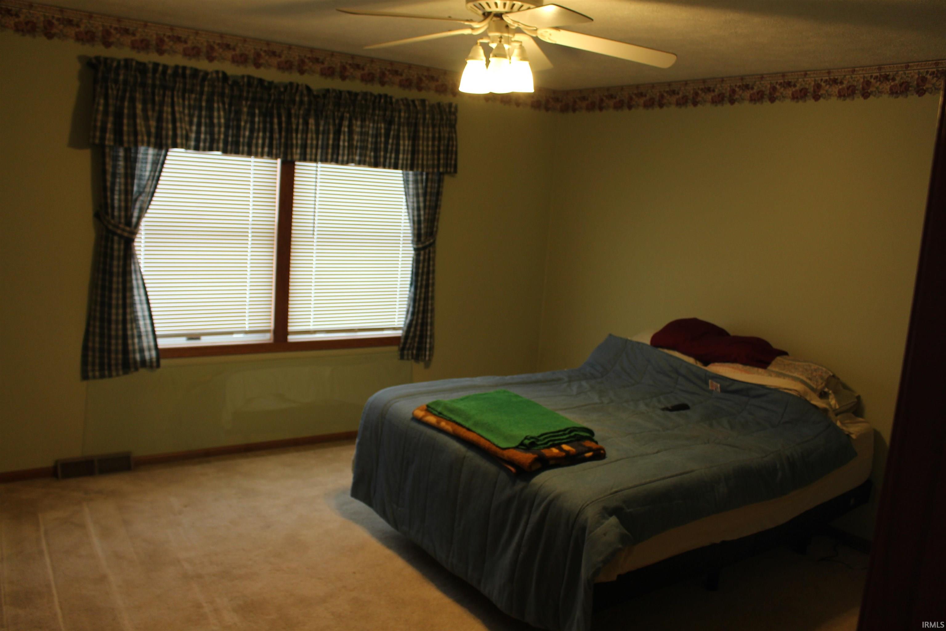 Bedroom featuring carpet floors and a ceiling fan