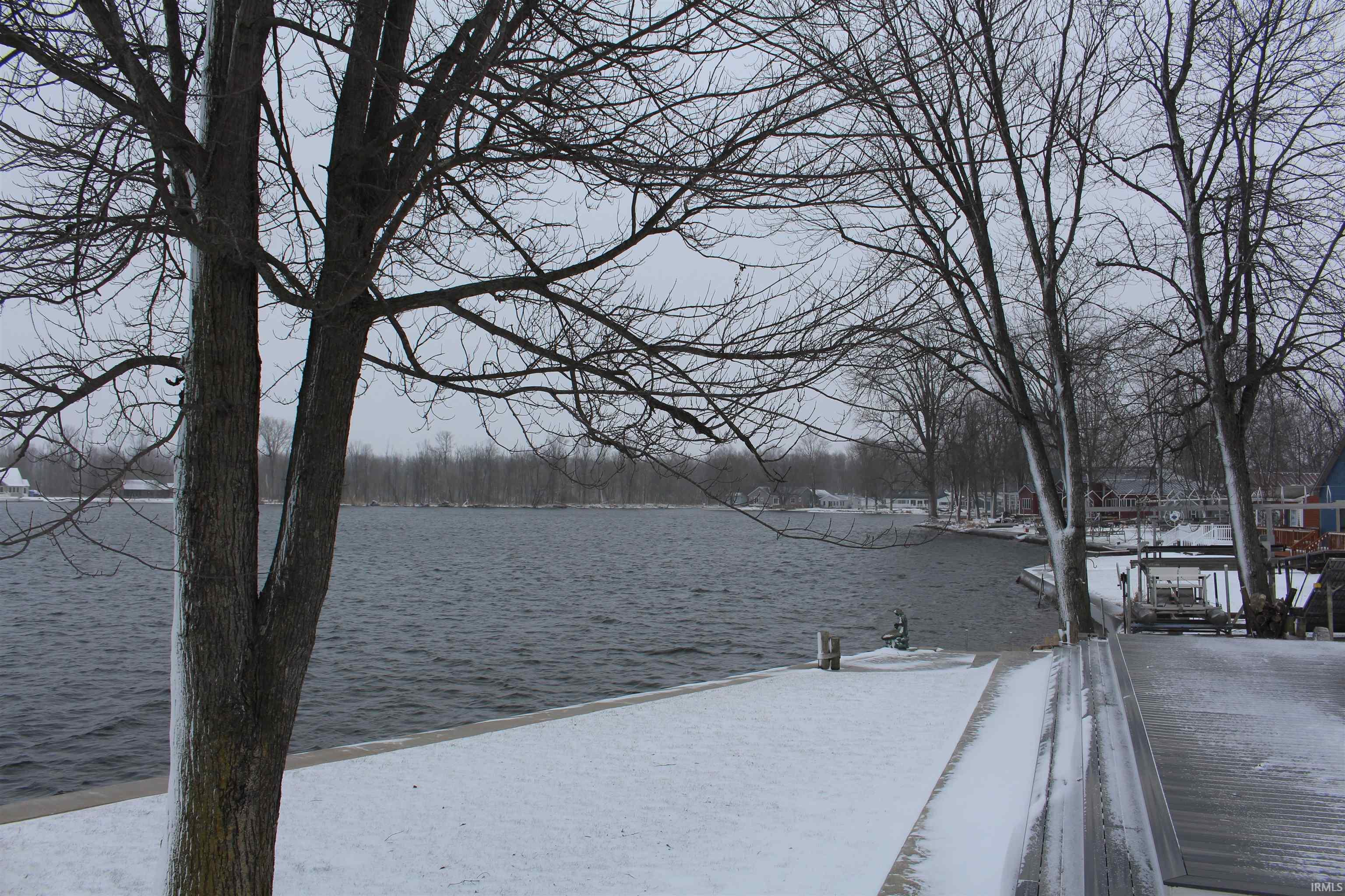 View of yard featuring a water view and a dock